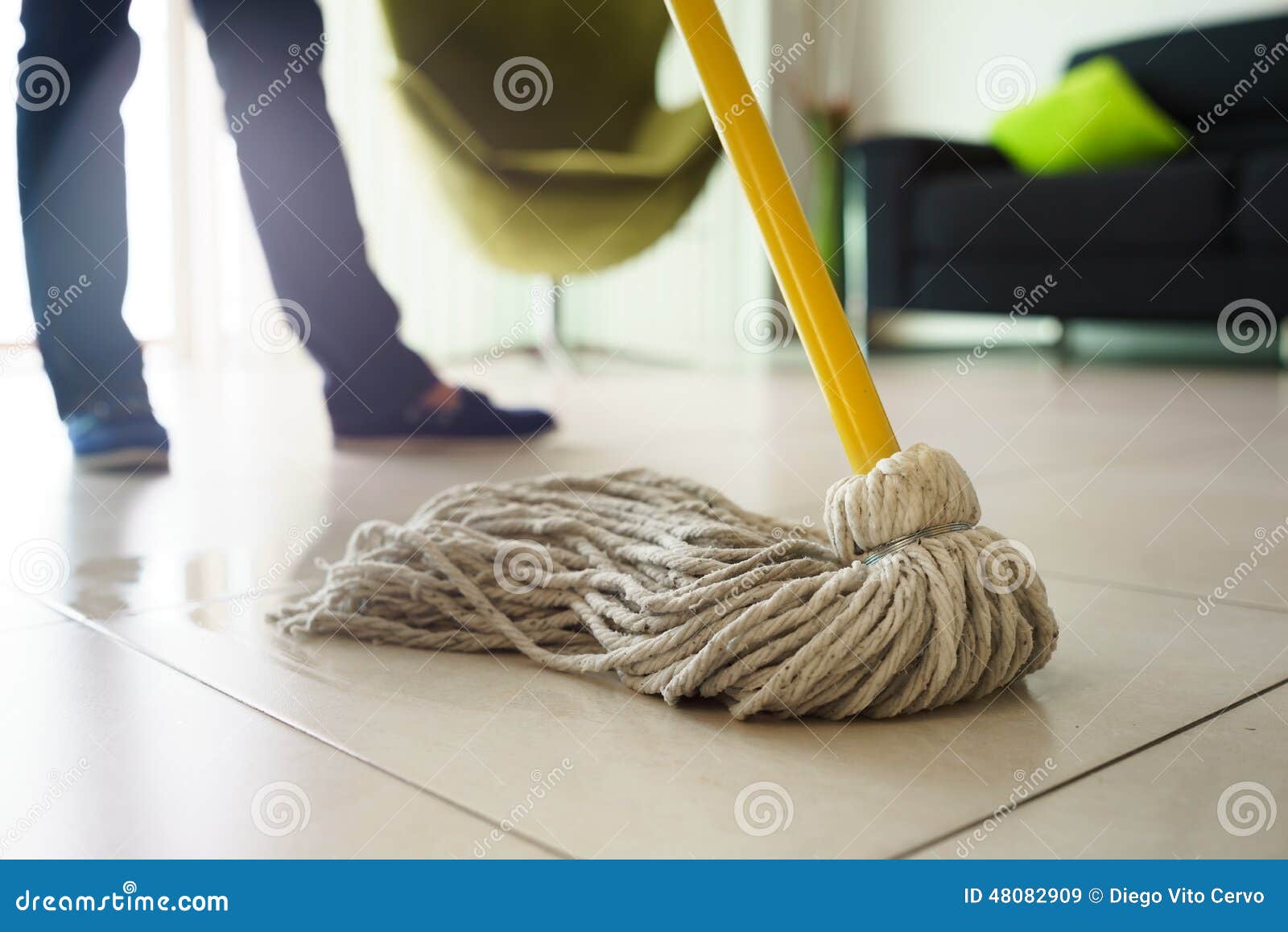 woman doing chores cleaning floor at home focus on mop