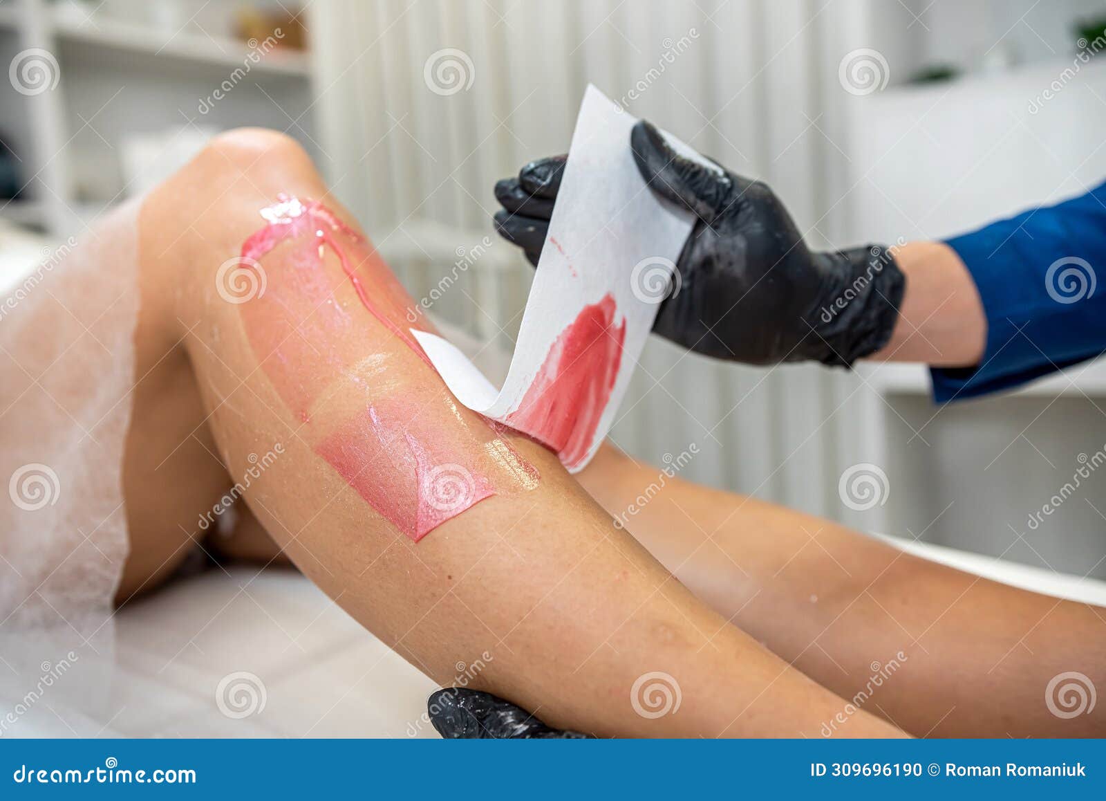 woman doing epilation shugaring with hot pasta removing unwanted hair on legs