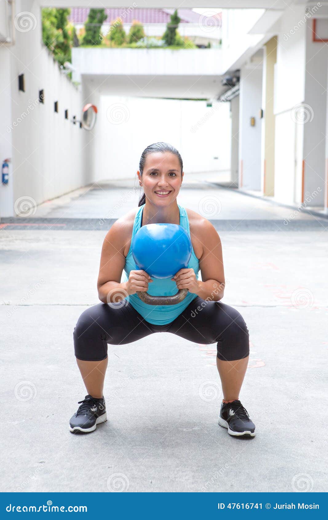 woman doing the kettlebell squat for muscle strengthening exercise