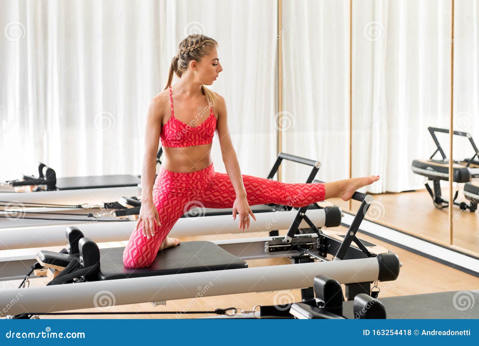 Woman Doing Leg Stretching Exercises in a Gym Stock Photo - Image