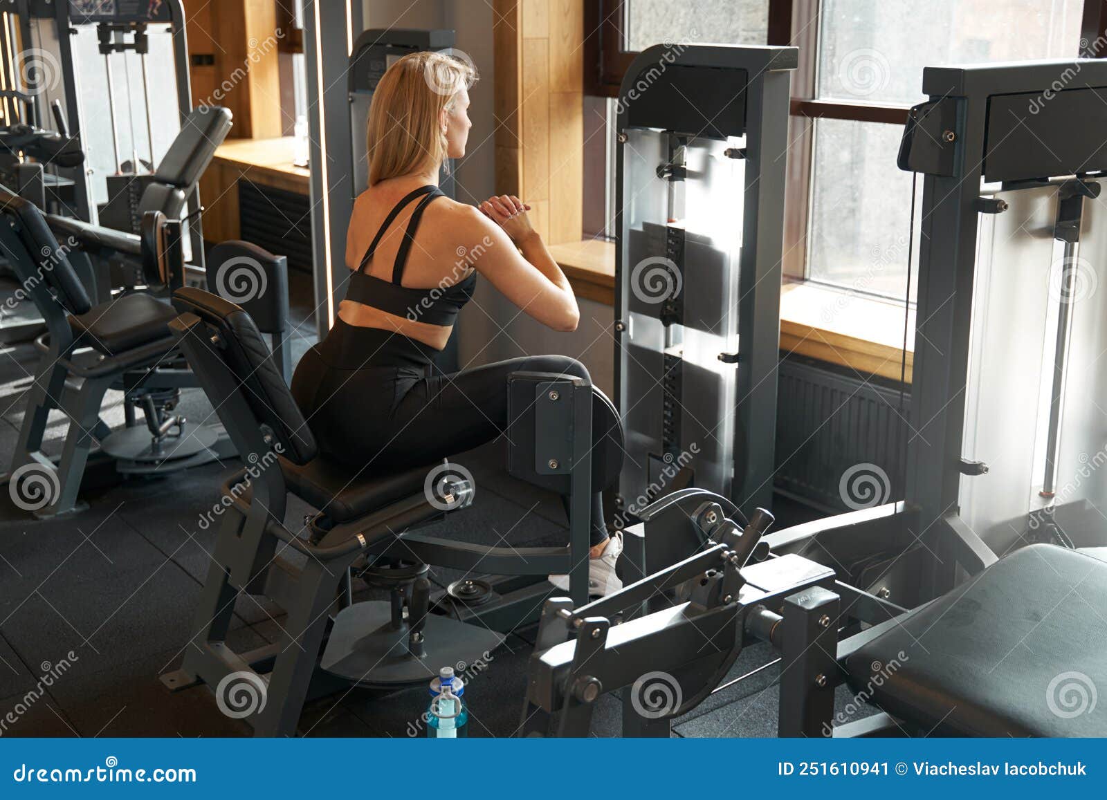Hip abduction woman exercise at gym indoor opening legs workout Stock Photo  - Alamy