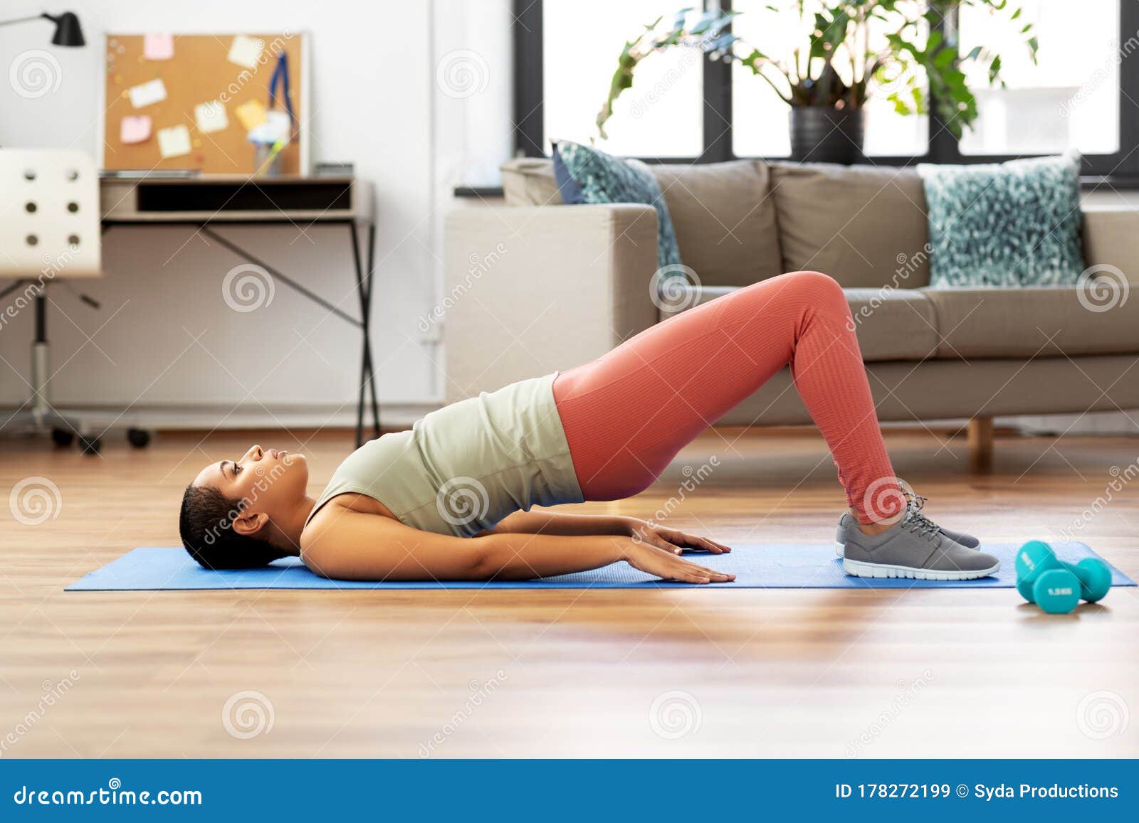 woman doing pelvic lift abdominal exercise at home