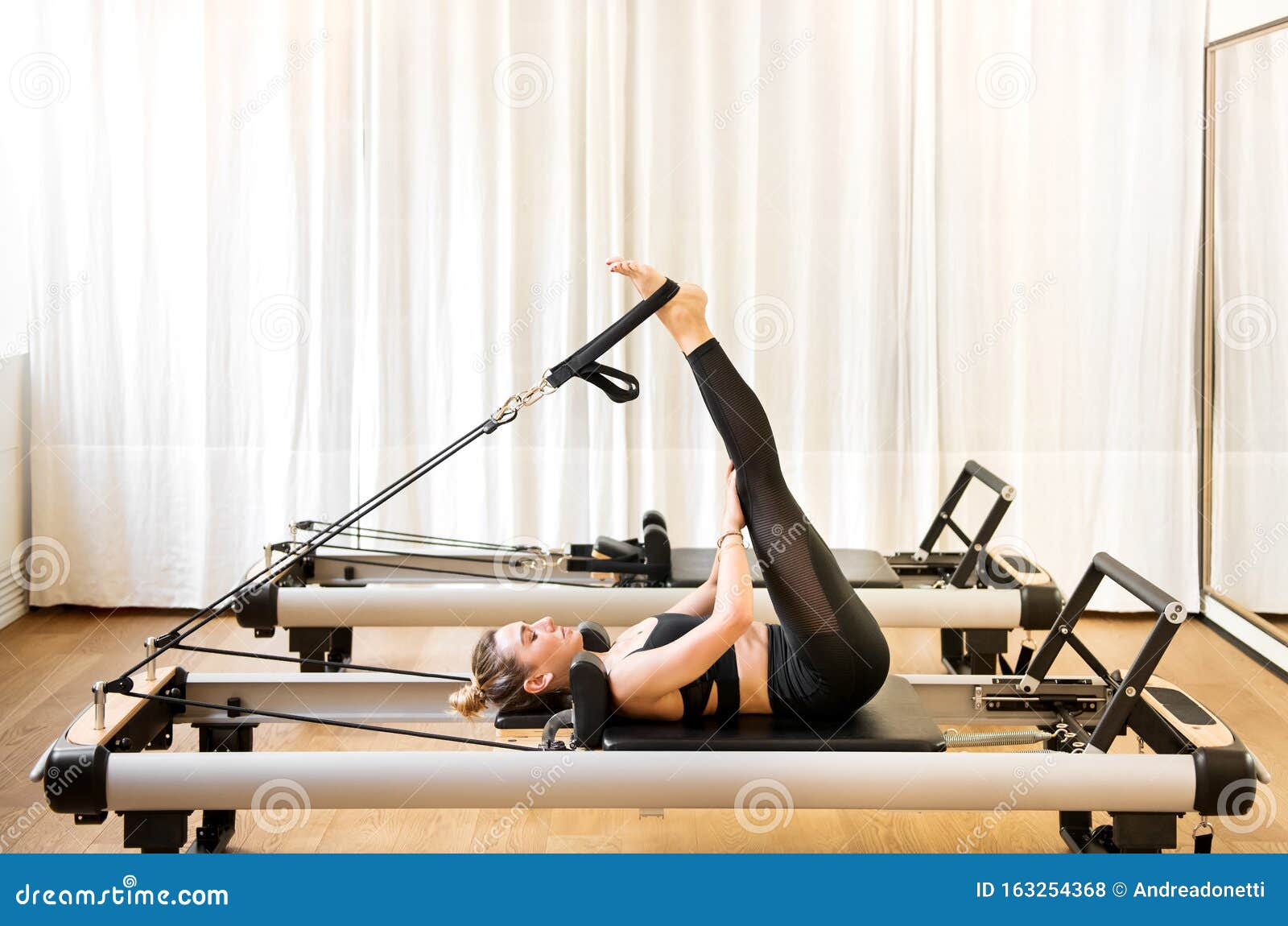 Woman Doing Short Spine Pilates Exercises Stock Photo - Image of