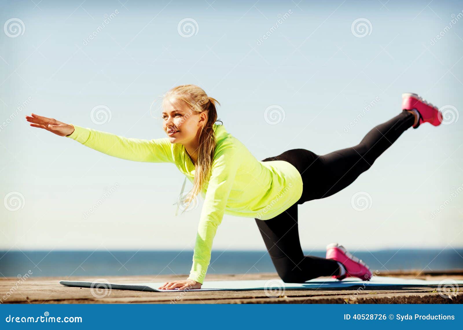 Sport and lifestyle concept - woman doing sports outdoors