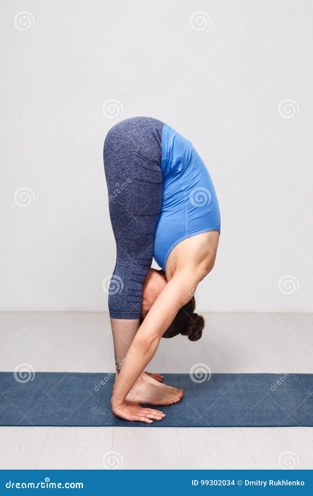 Woman Doing Yoga Asana Uttanasana - Standing Forward Bend Stock Photo -  Image of sport, bend: 99302034