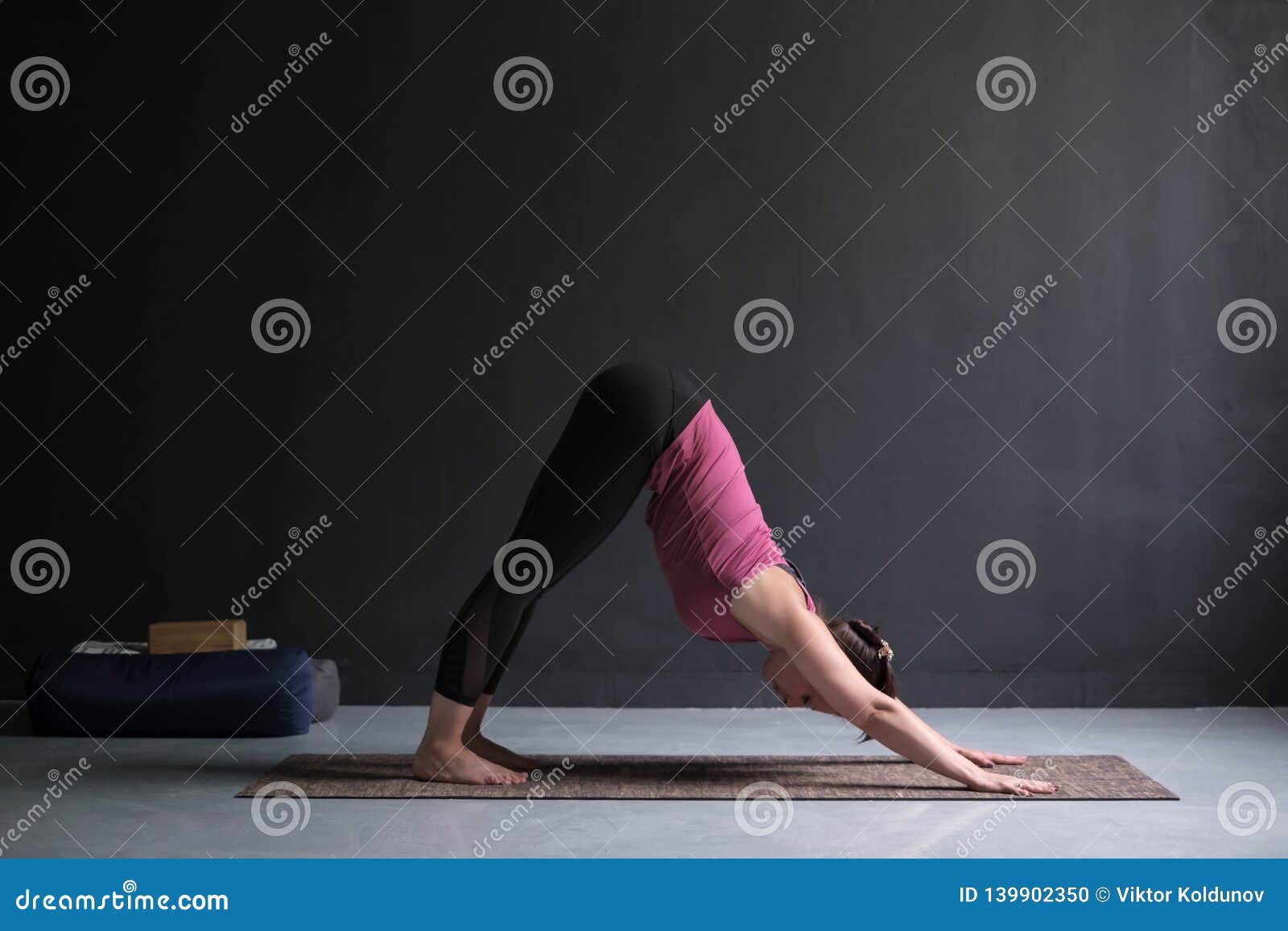 woman doing yoga exercise downward facing dog pose, adho mukha svanasana