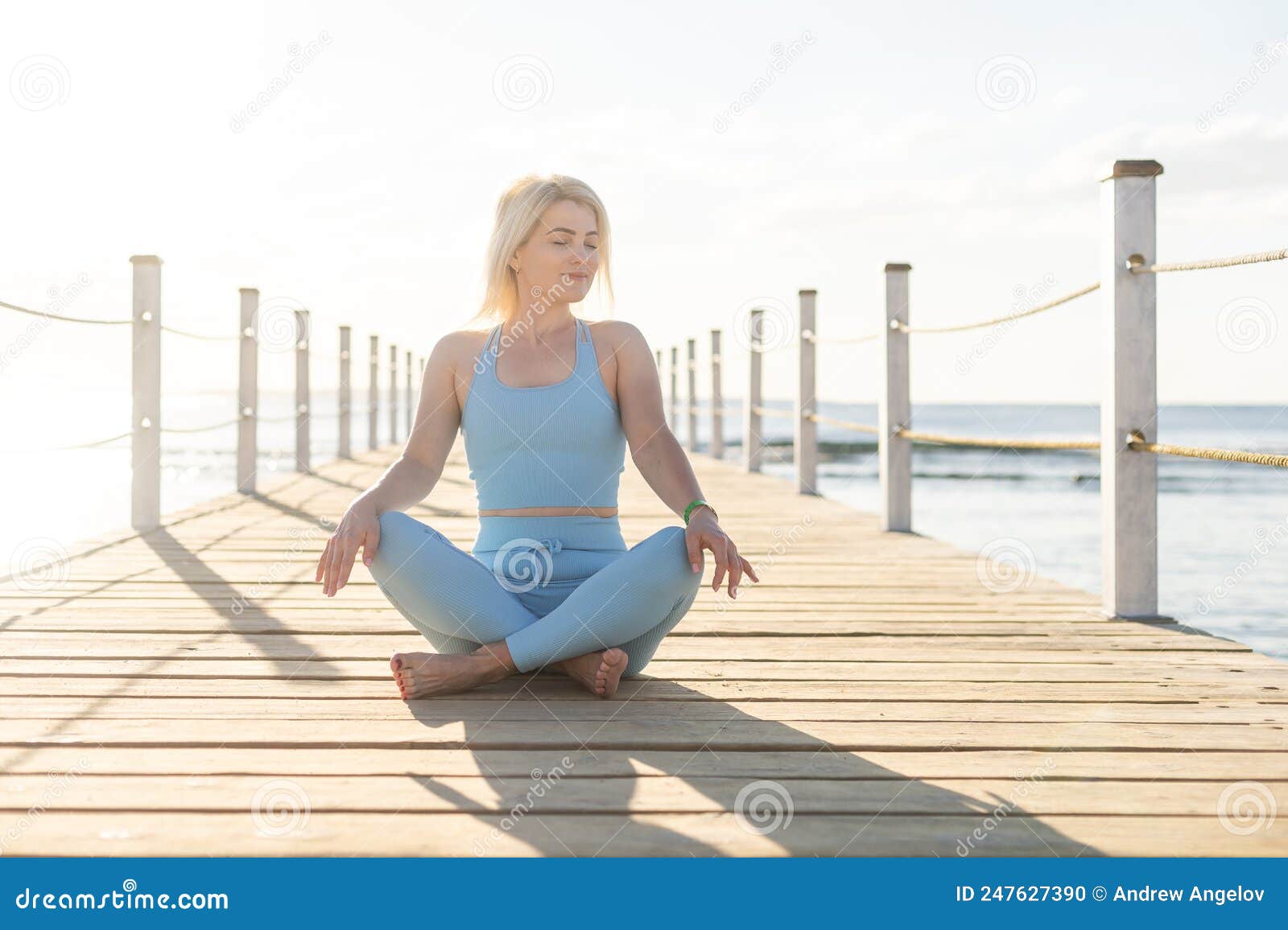 Woman Doing Yoga Exercises By The Sea Stock Photo Image Of Fitness Wellbeing