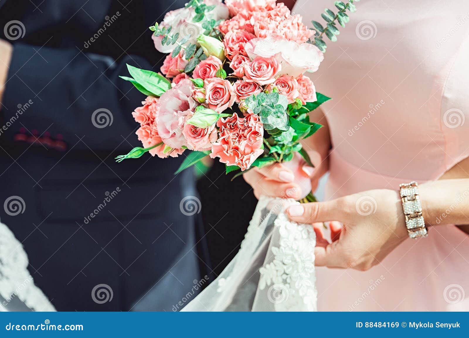Woman in a Dress Holding Wedding Bouquets of White and Biege Roses ...