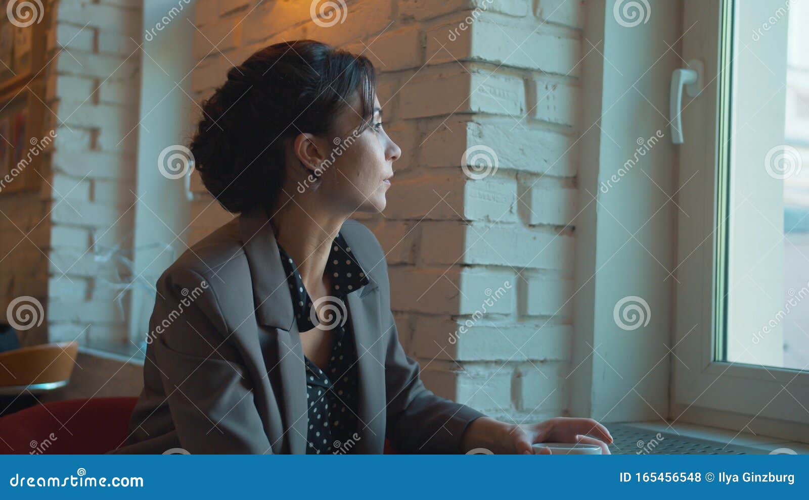 woman drink coffee, look out the window thoughtfully