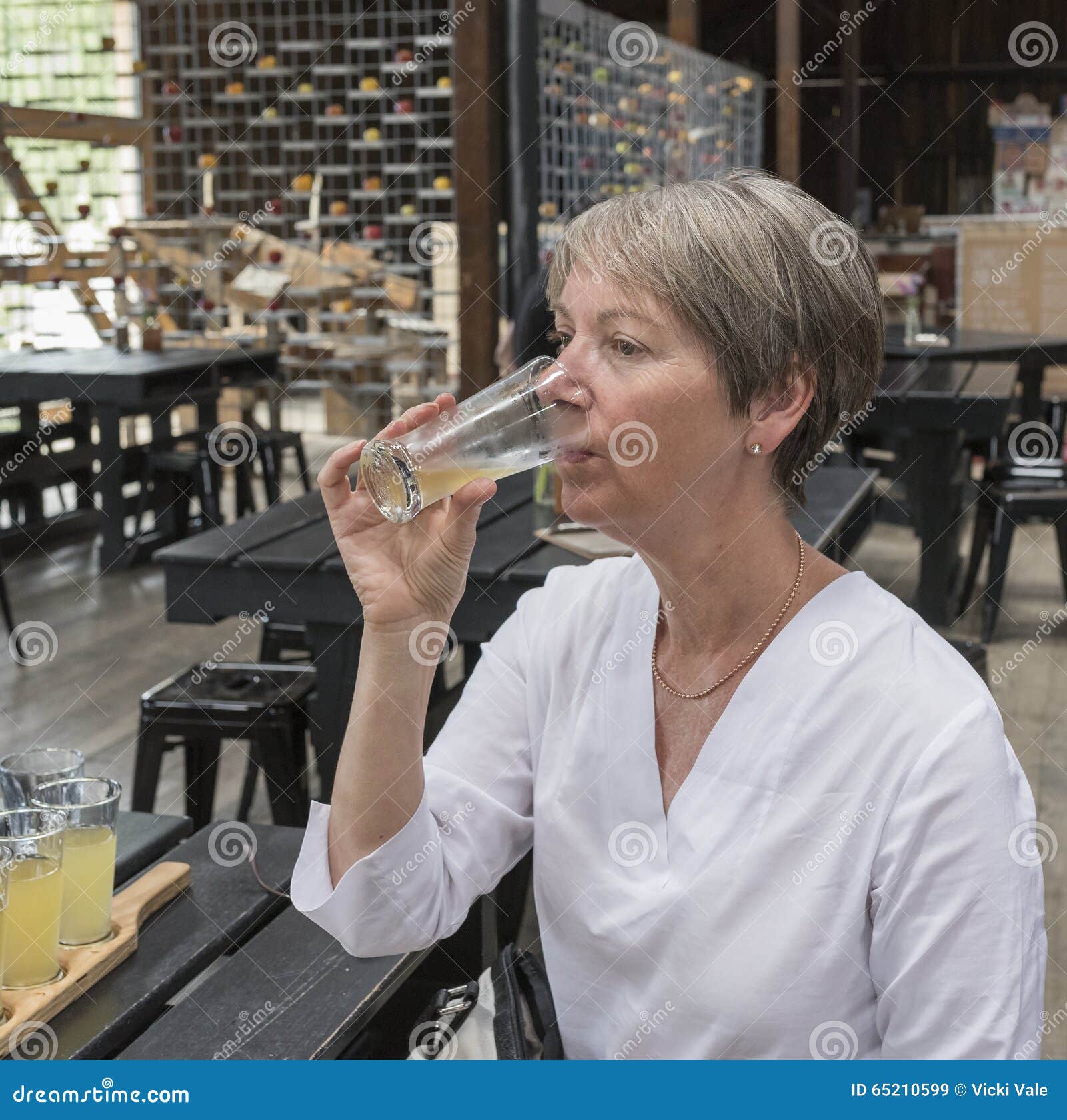 Woman Drinking Apple Cider. Stock Image Image of female, table 65210599