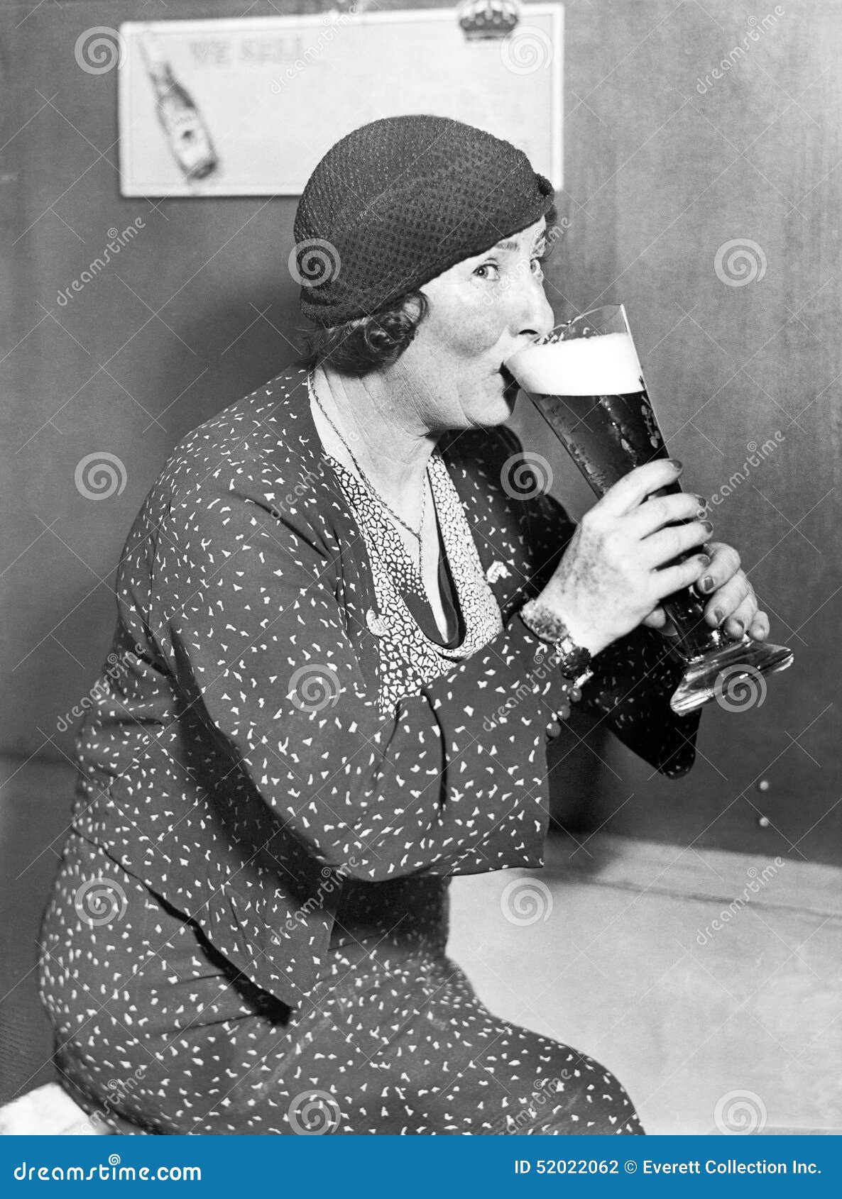 woman drinking out of a big beer glass
