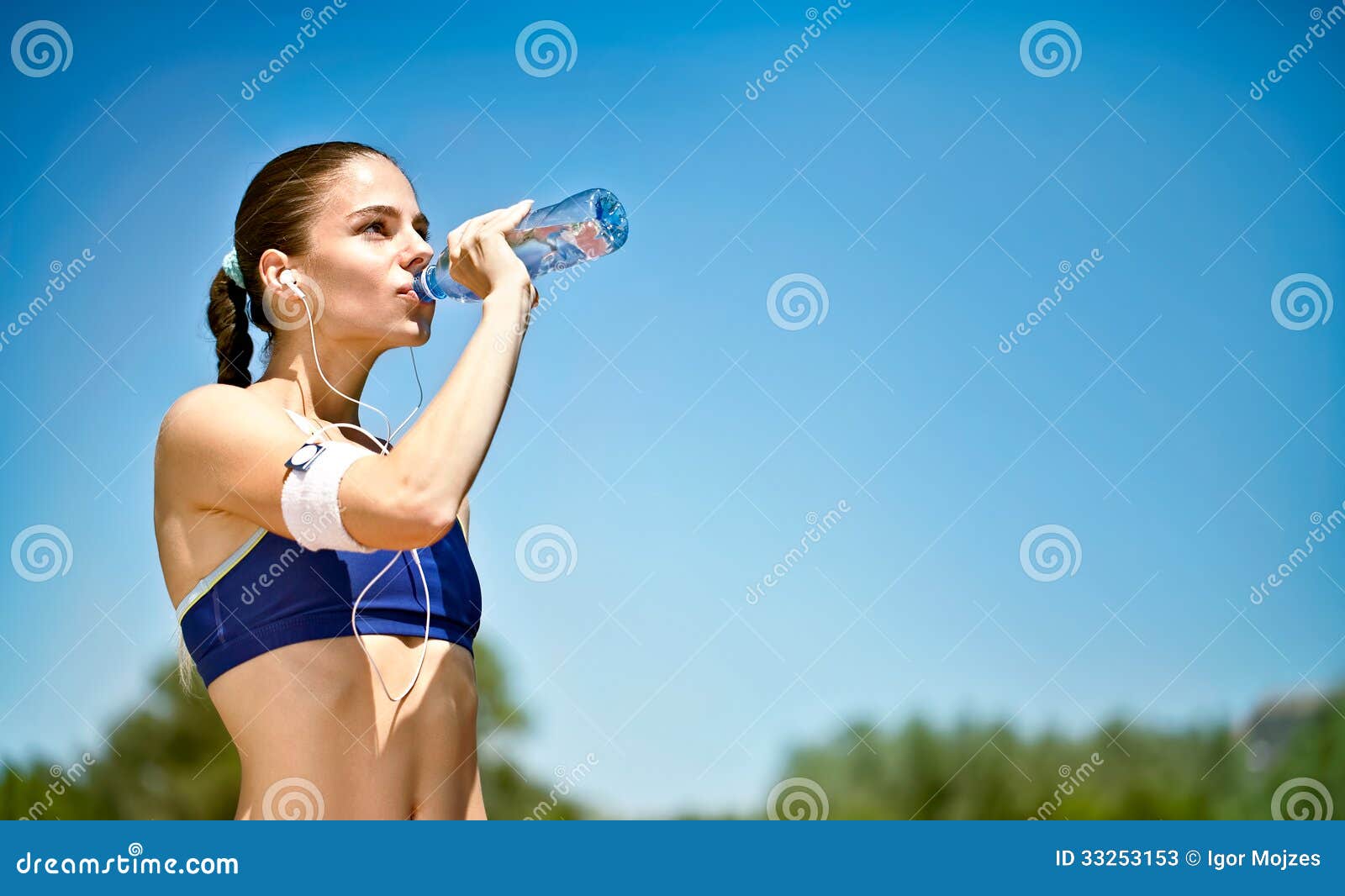 woman drinking water after sport activities