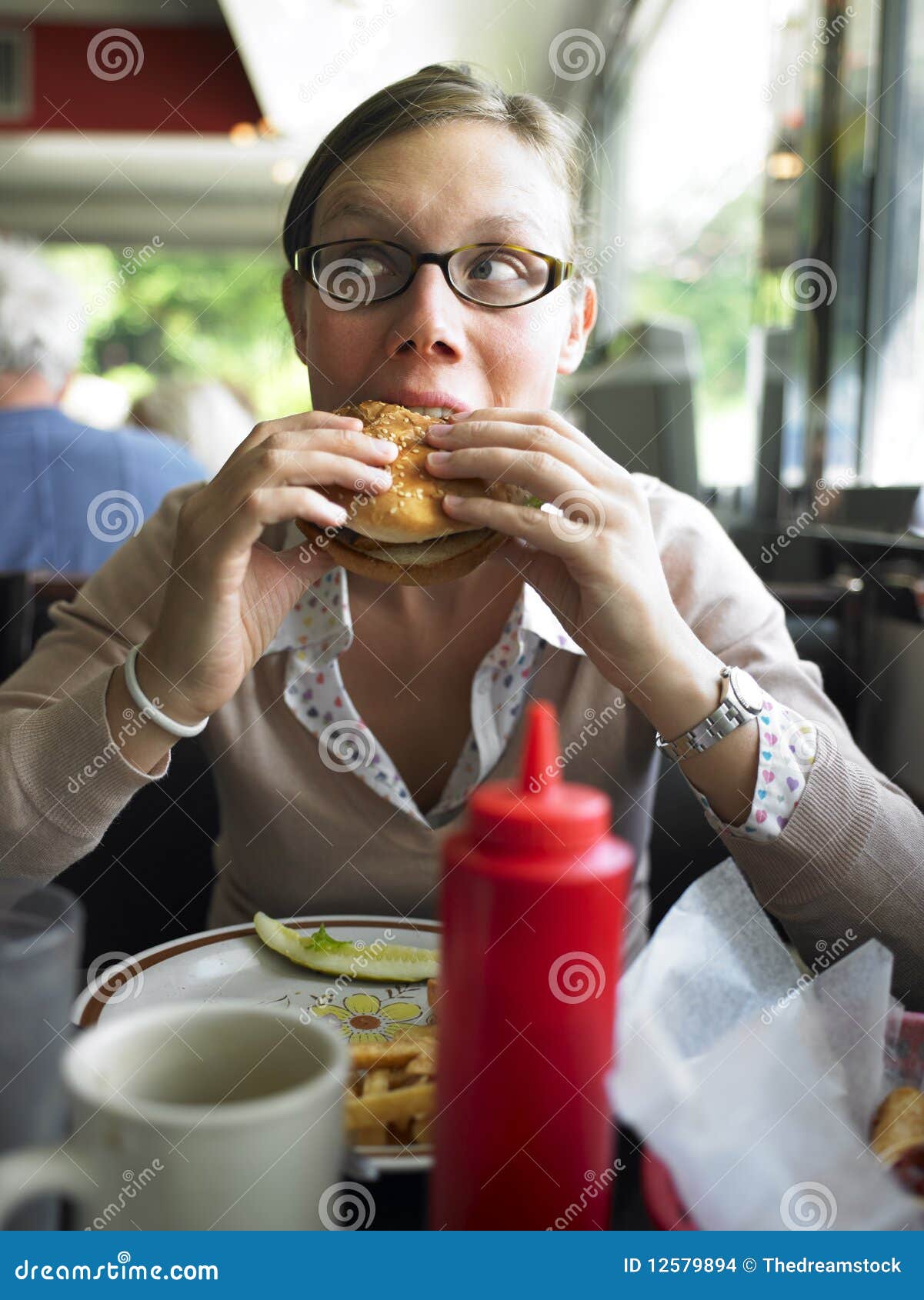 Woman Eating Burger stock photo. Image of head, hair - 12579894