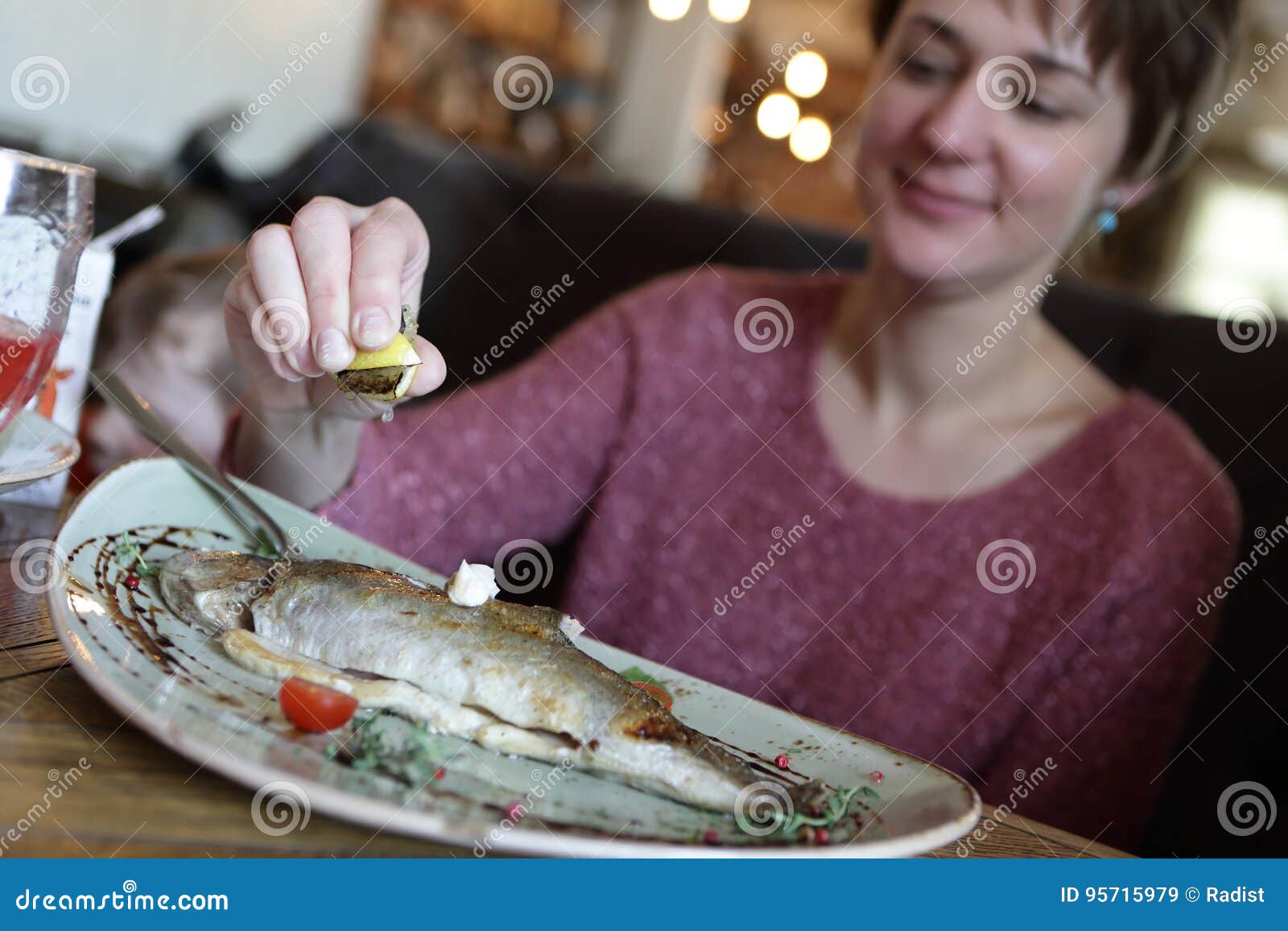 Woman eating fried trout stock image. Image of horizontal 95715979