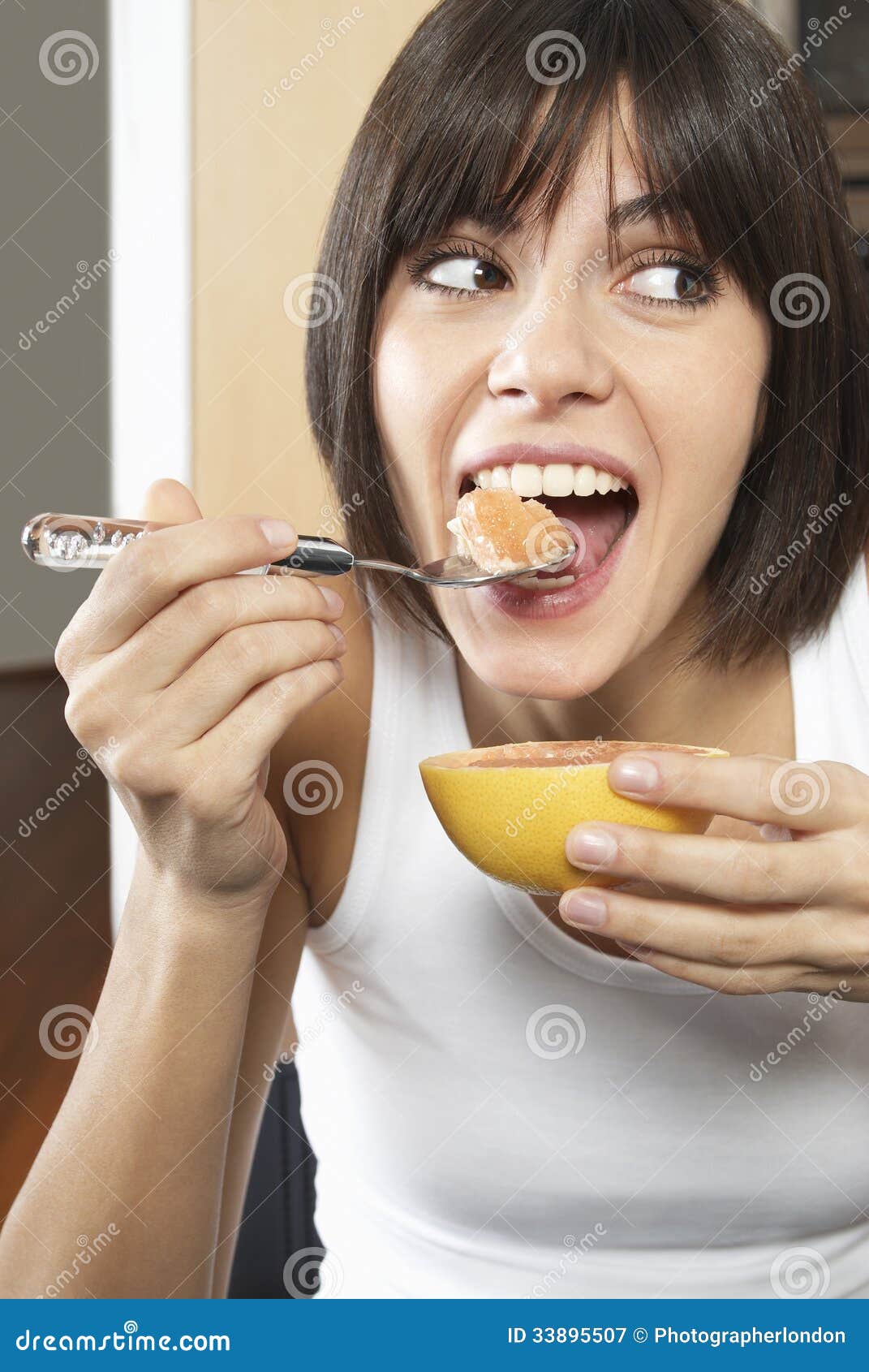 Woman Eating Grapefruit stock image. Image of eating 33895507