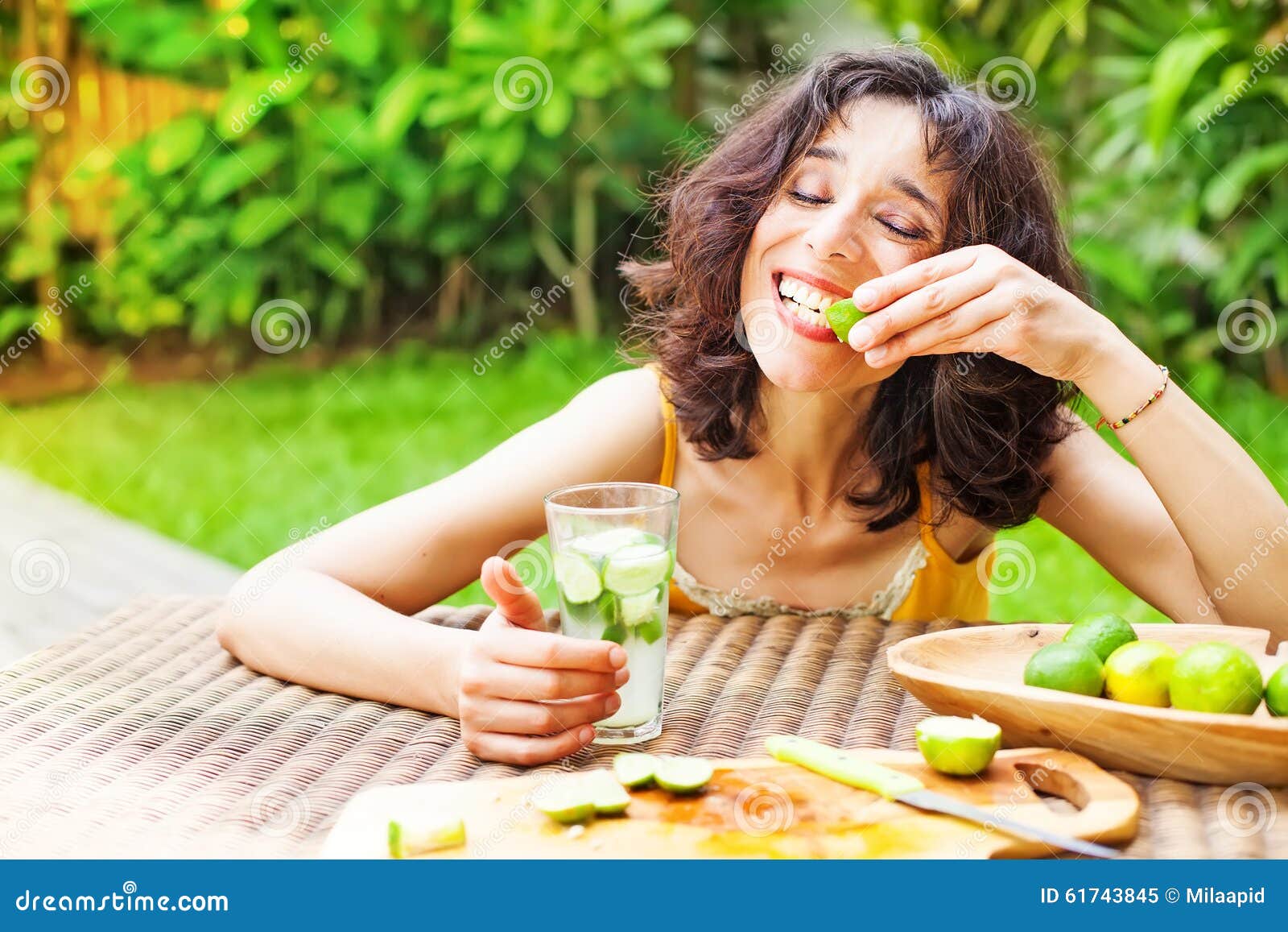 Woman eating a lemon stock image. Image of healthy, fresh 61743845