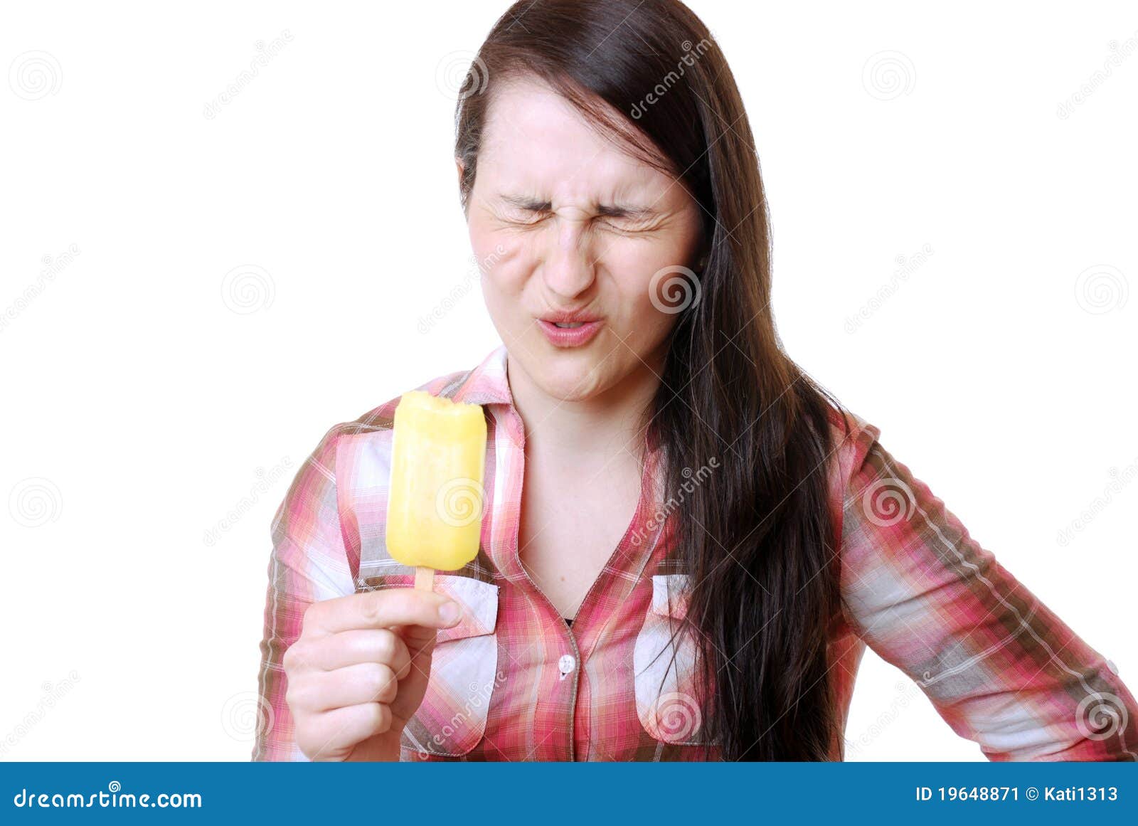 woman eats a sour popsicle