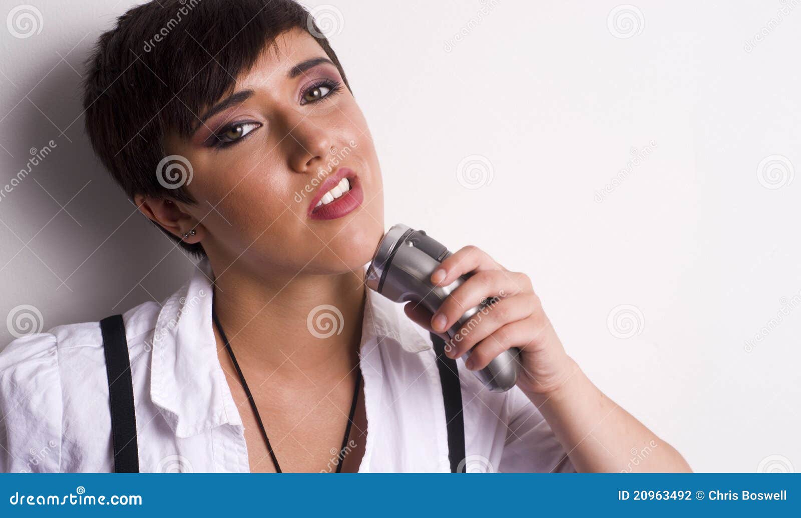 Young Woman Shaves Face With Electric Shaver Stock Photography Image