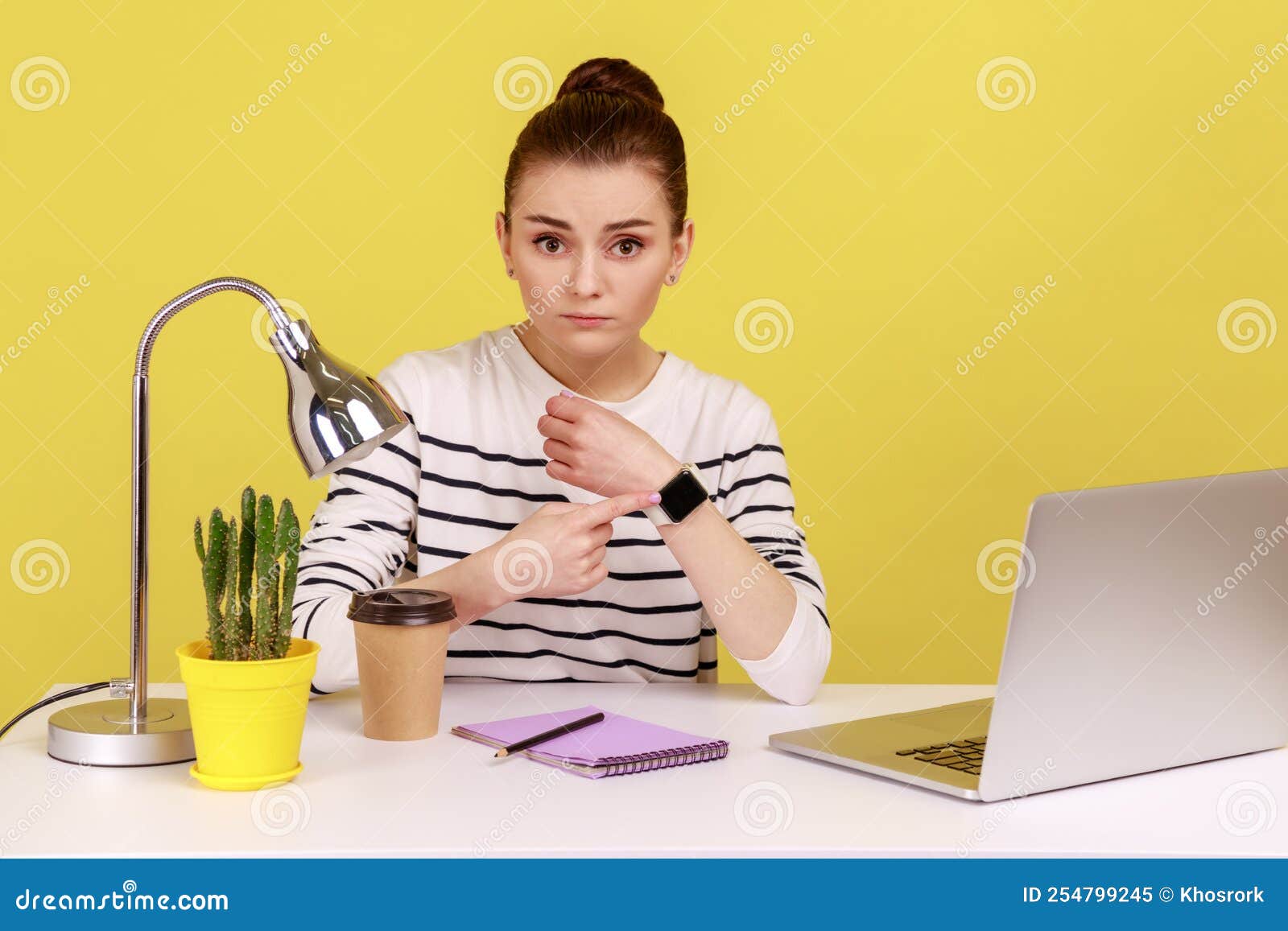 Woman Employee Sitting in Office and Pointing To Watch on Her Hand ...