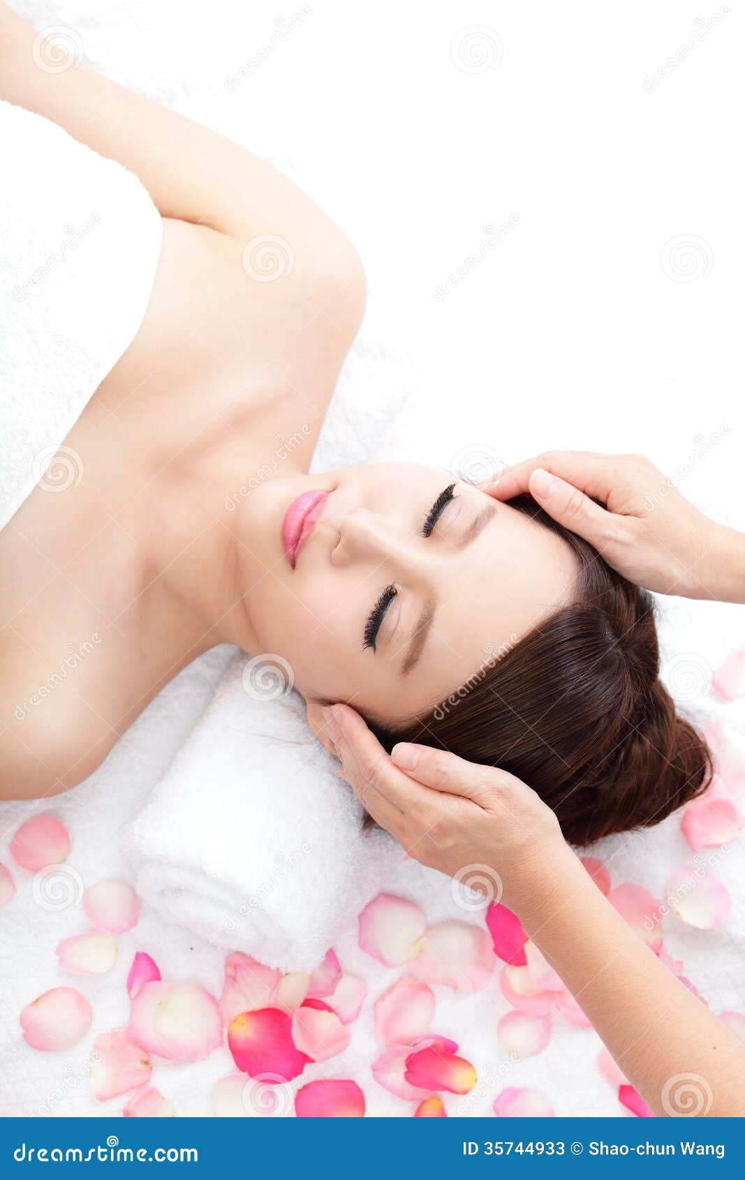 Woman Enjoy Receiving Face Massage At Spa With Roses Stock Image
