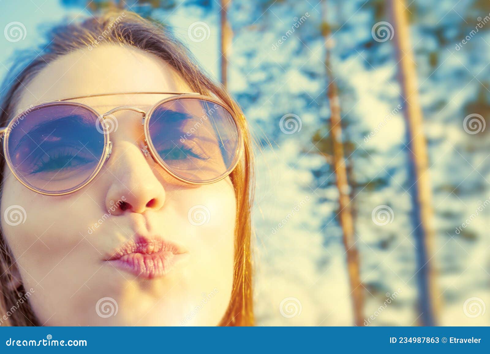 woman tourist enjoying fresh air in the woods and sending air kiss