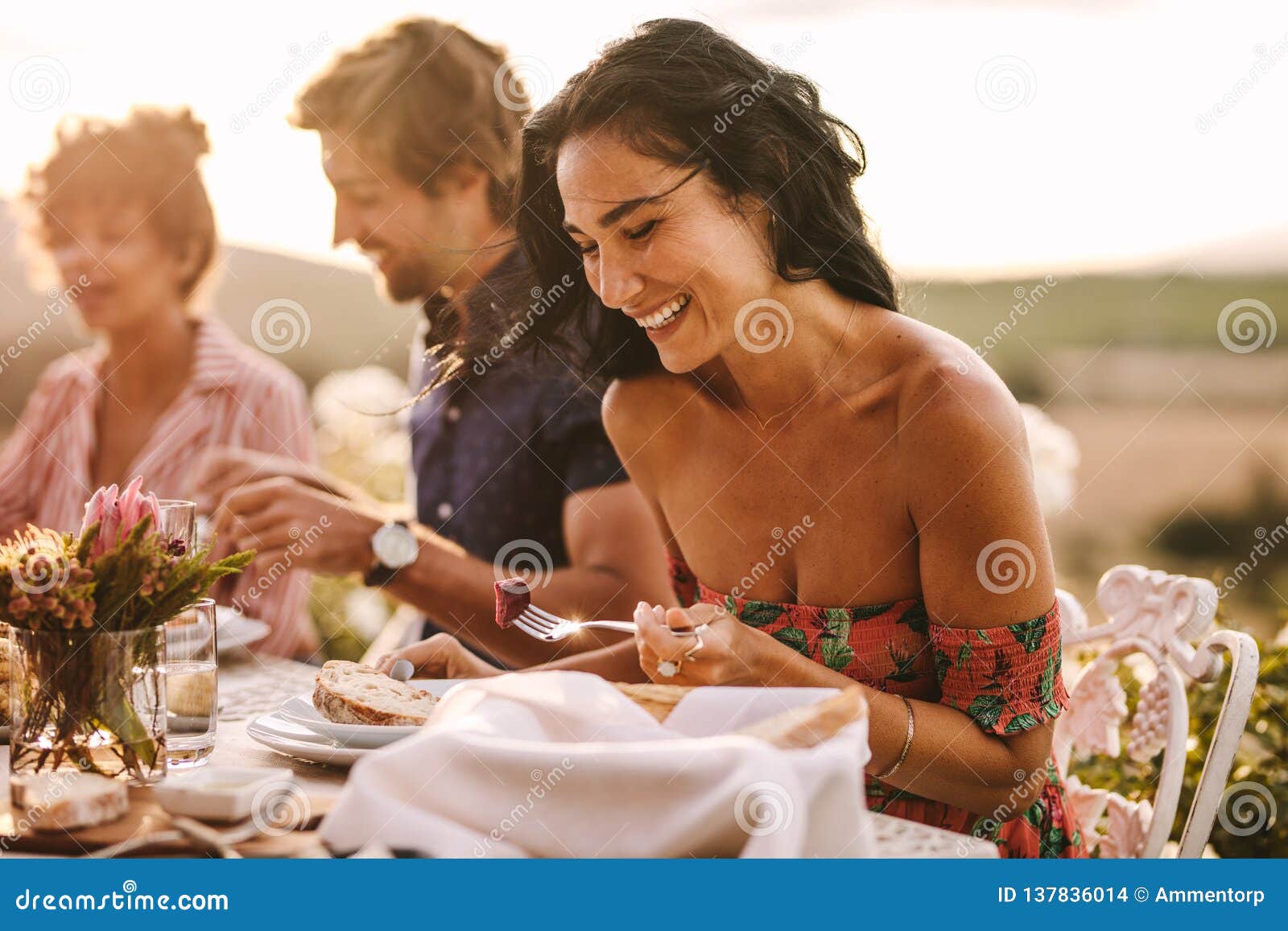 Woman Enjoying Having Food With Friends At A Party Stock
