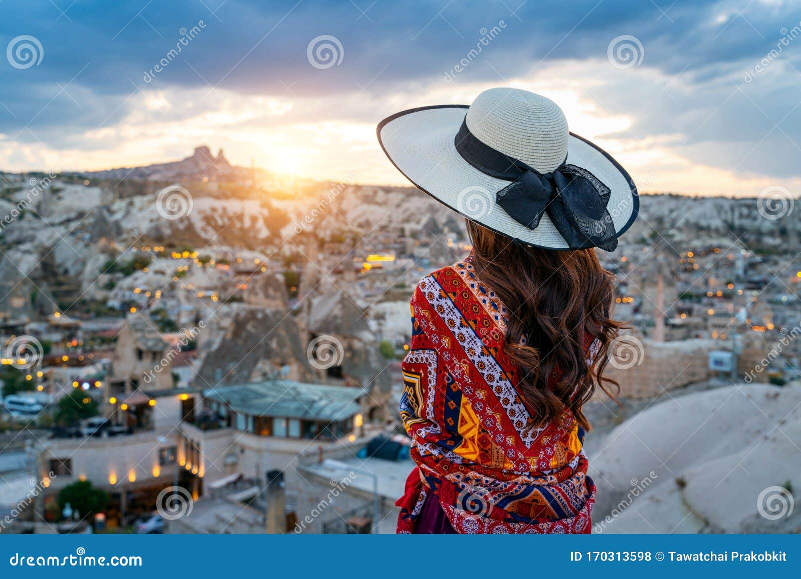 woman enjoying view of goreme town, cappadocia in turkey.