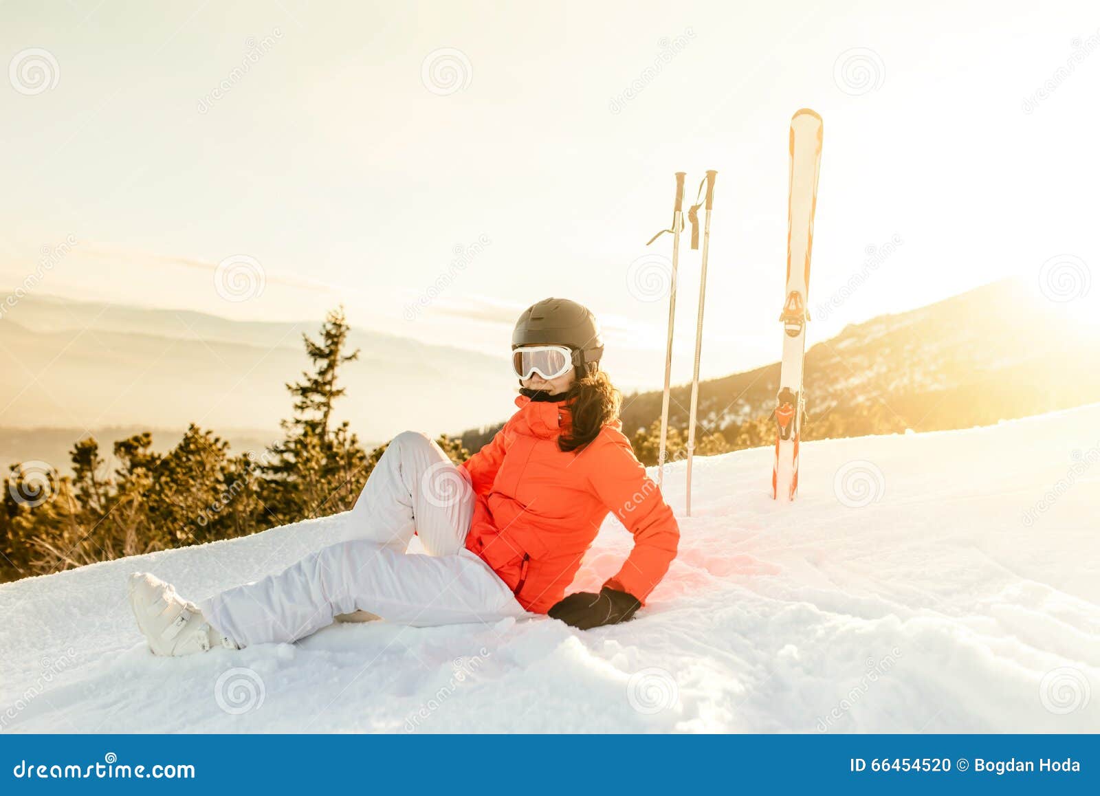 woman enjoying the view from mountain slopes, relaxing