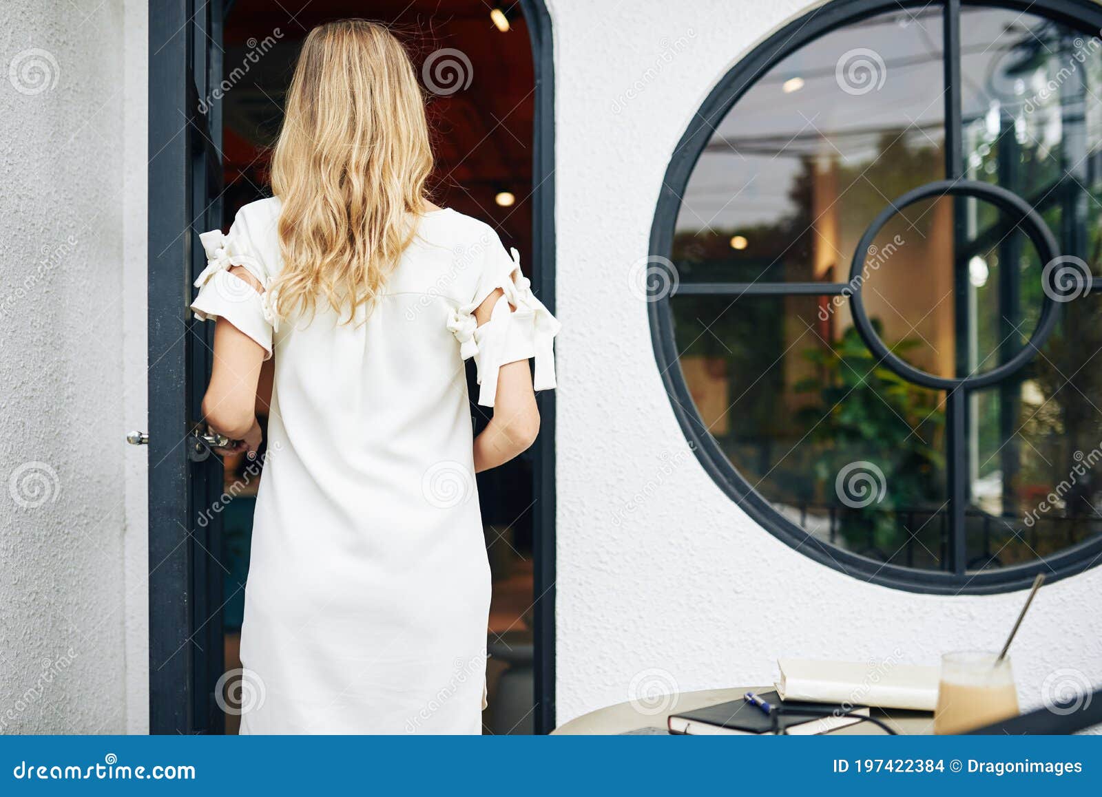 Woman entering cafe door stock photo. Image of entering - 197422384