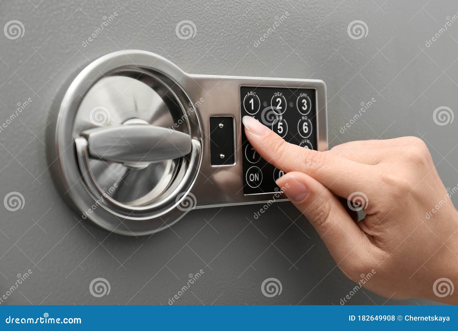 woman entering code on keypad of safe, closeup