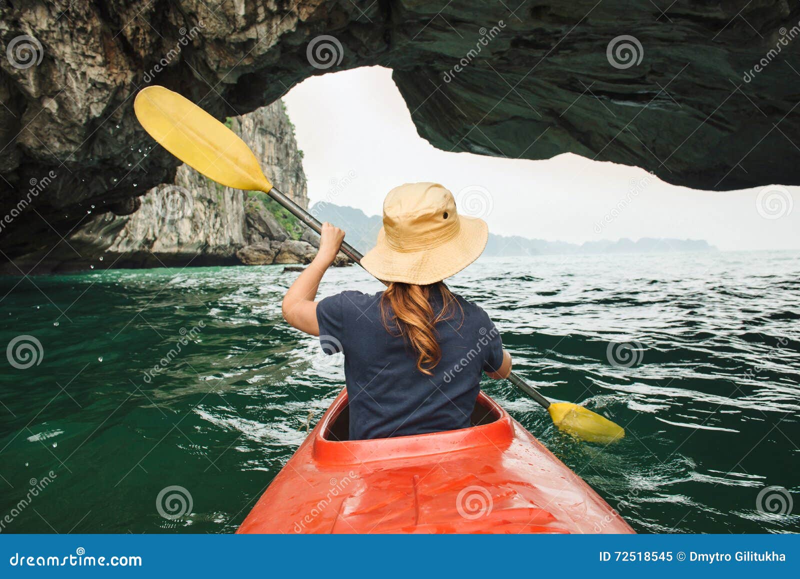 woman explore ha long bay on kayak