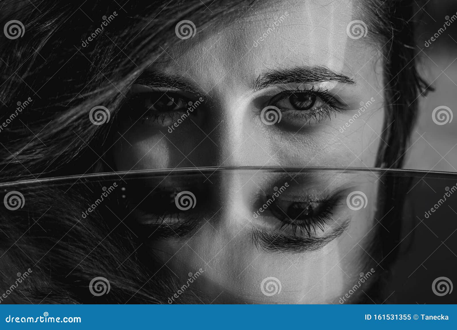 woman eyes closeup reflected in mirror. hypnotize strong look. hypnotic deeply penetrating glance. revengeful insidious expectant