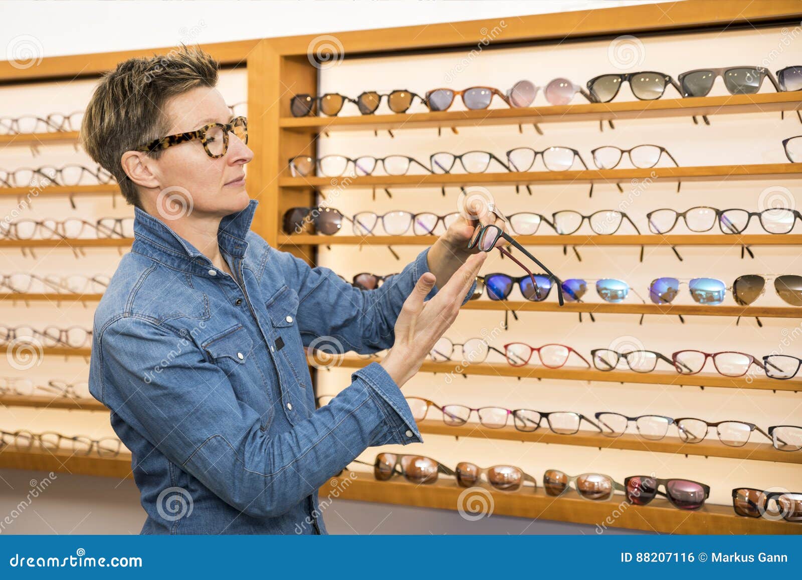 Woman in a eyewear store stock photo. Image of happy 88207116