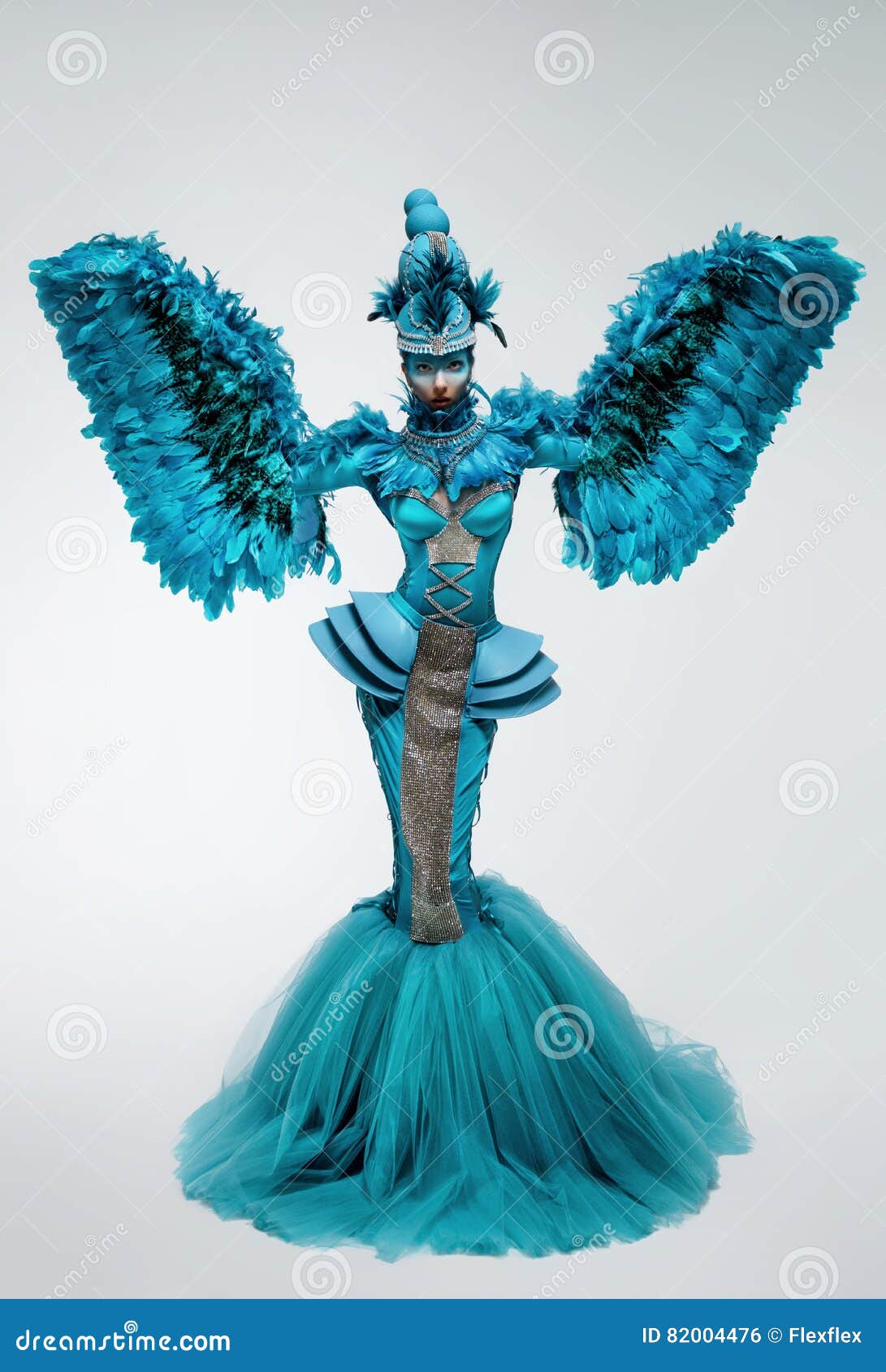 woman in fantasy costume with feather sleeves