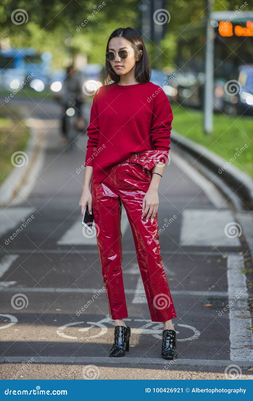 Woman with brown Louis Vuitton checkered bag on September 22, 2018 in  Milan, Italy Stock Photo