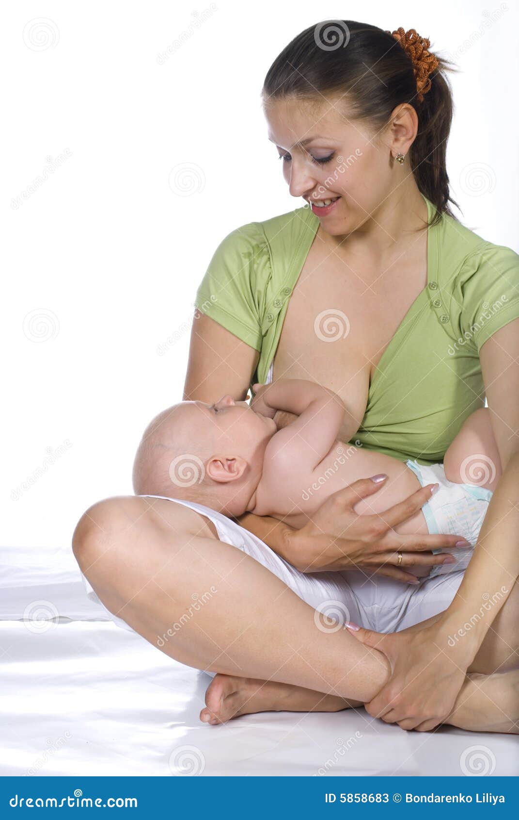 The woman feeding a baby stock image. Image of breast - 5858683
