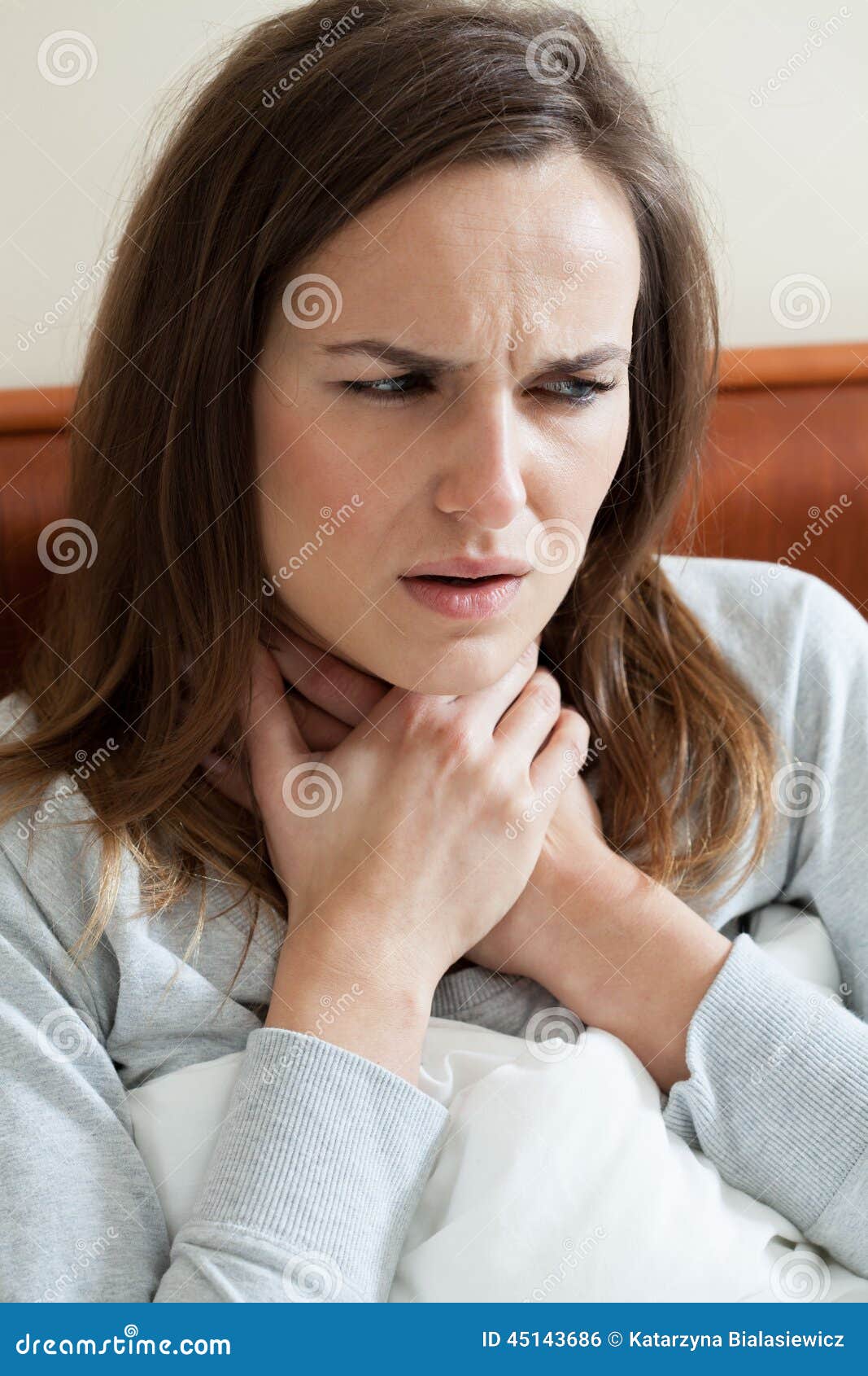 Woman feeling sore throat stock photo. Image of bedding 45143686