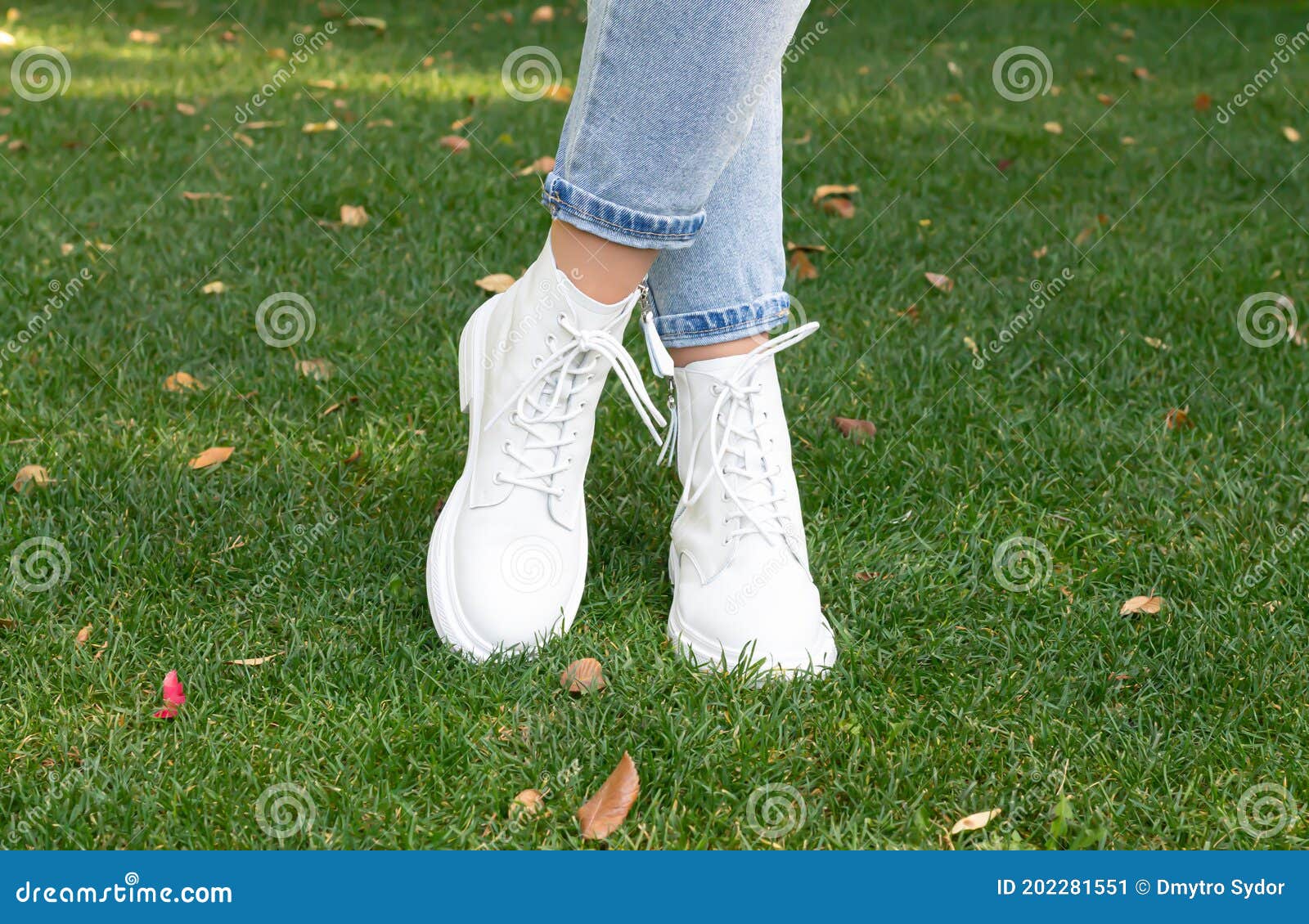Woman Feet in Fashion White Casual Boots on Green Grass Background ...