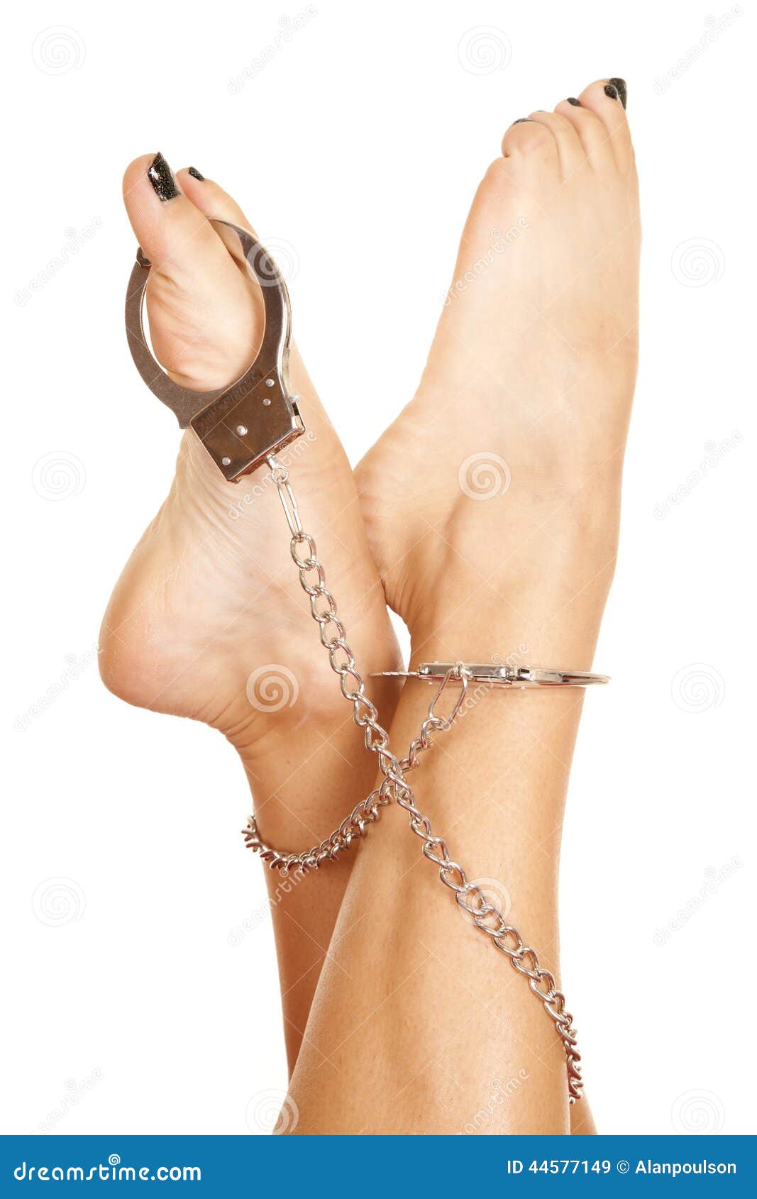 Sexy Long Female Legs In High Heel Shoes And Leg Cuffs Against