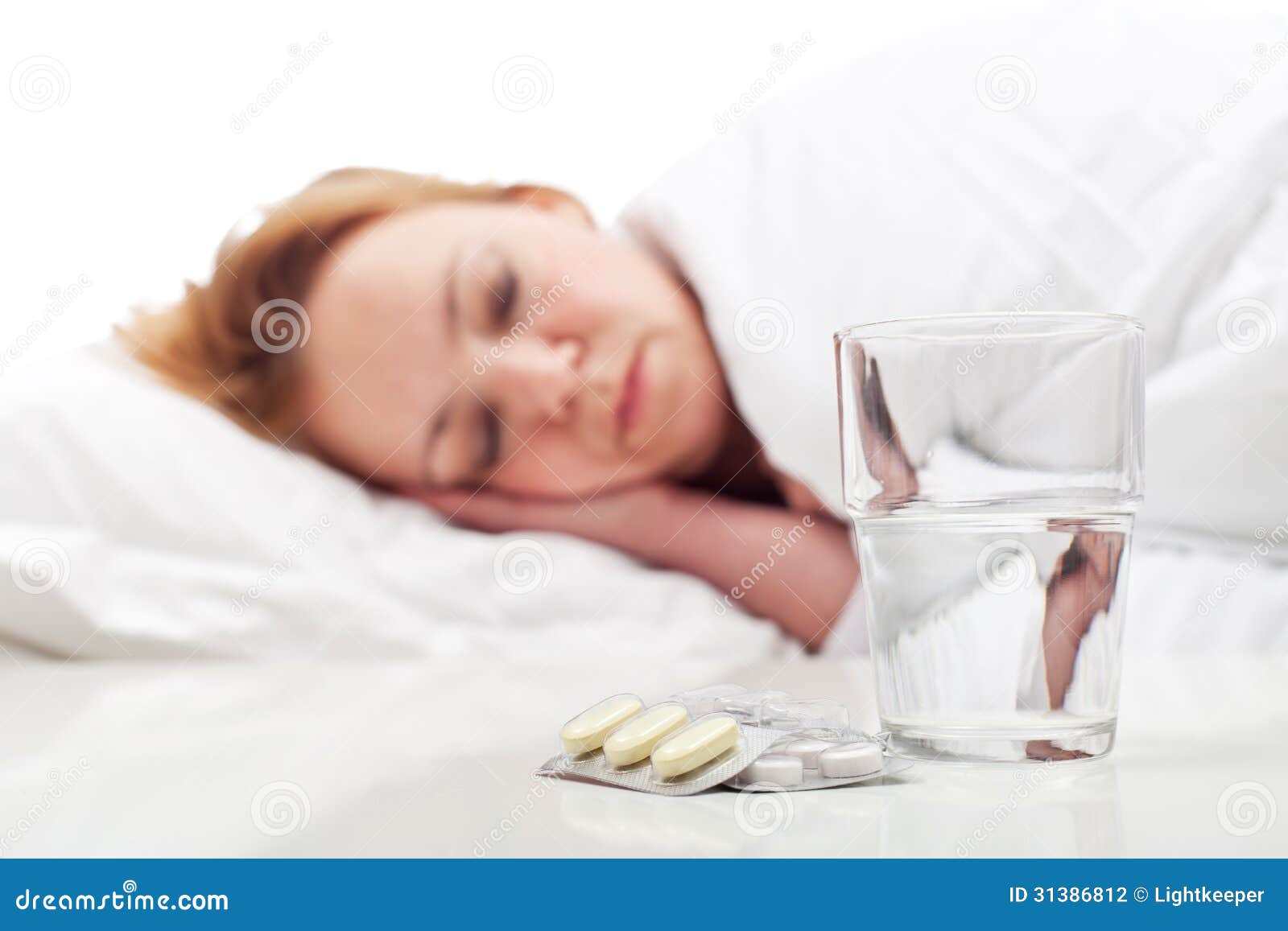 woman fighting sickness with pills and resting
