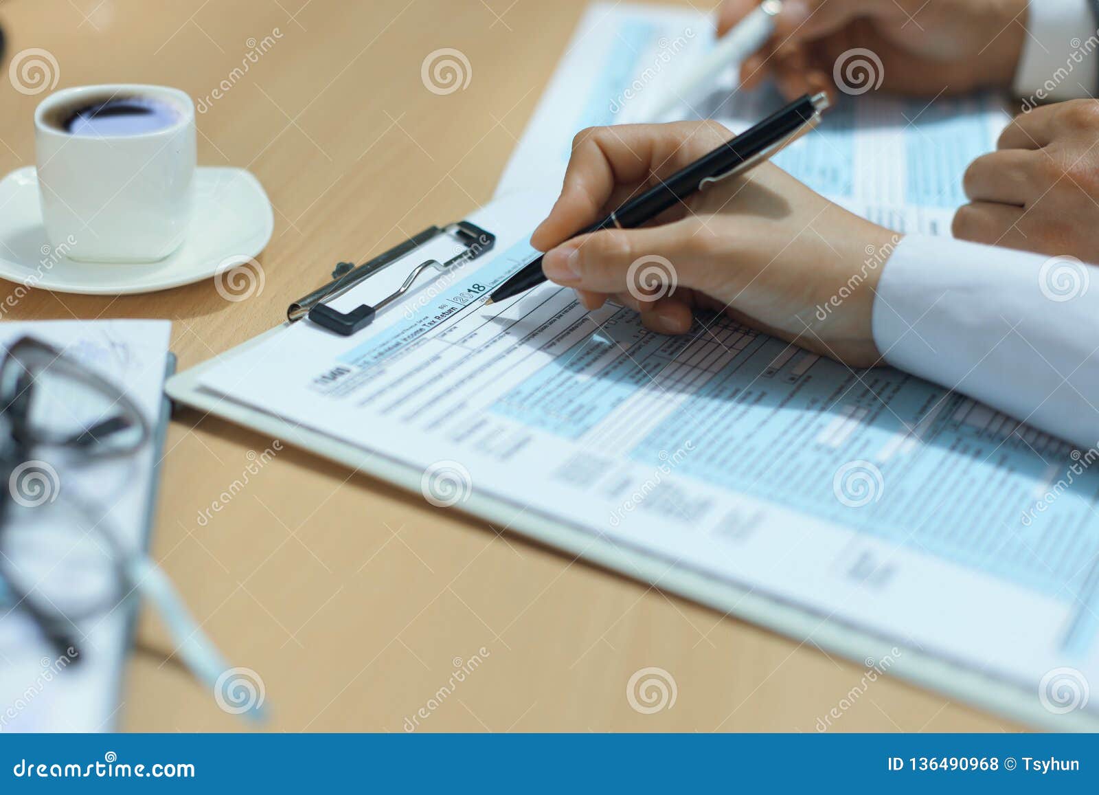 Woman Filling in U.S. Individual Income Tax Return, Tax 1040 at Table. Stock Photo - Image of ...