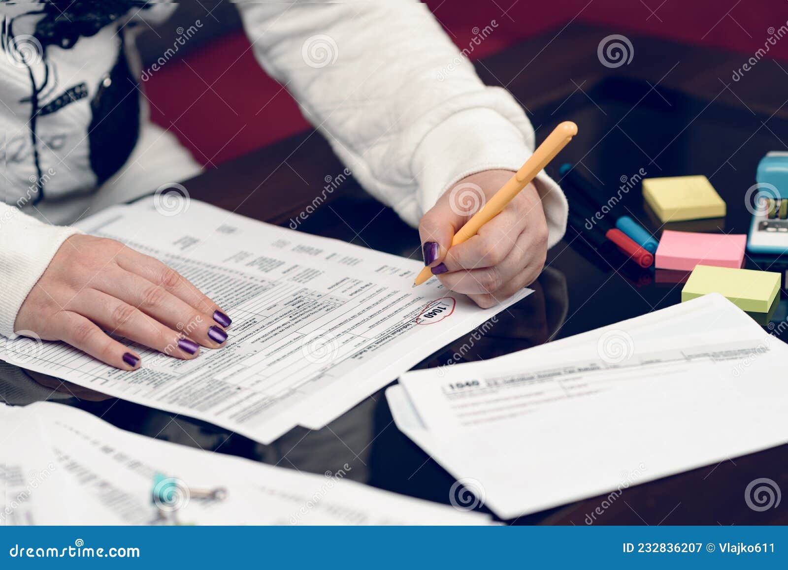 Woman Fills the Tax Form, Working with Tax Documents. Form 1040 ...