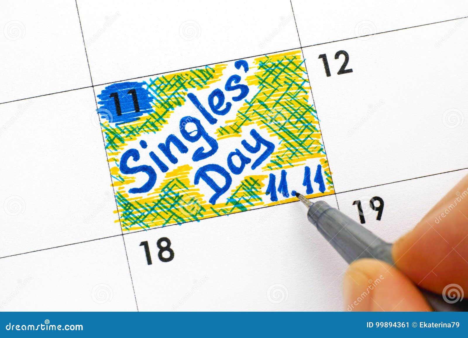 woman fingers with pen writing reminder singles day 11.11 in cal