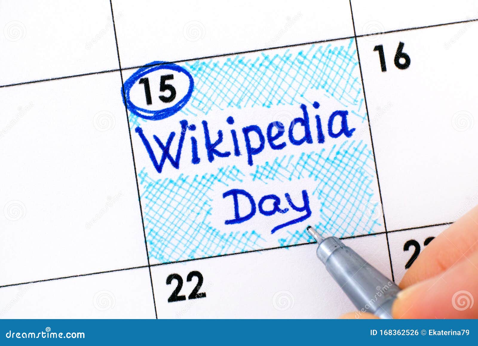 woman fingers with pen writing reminder wikipedia day in calendar