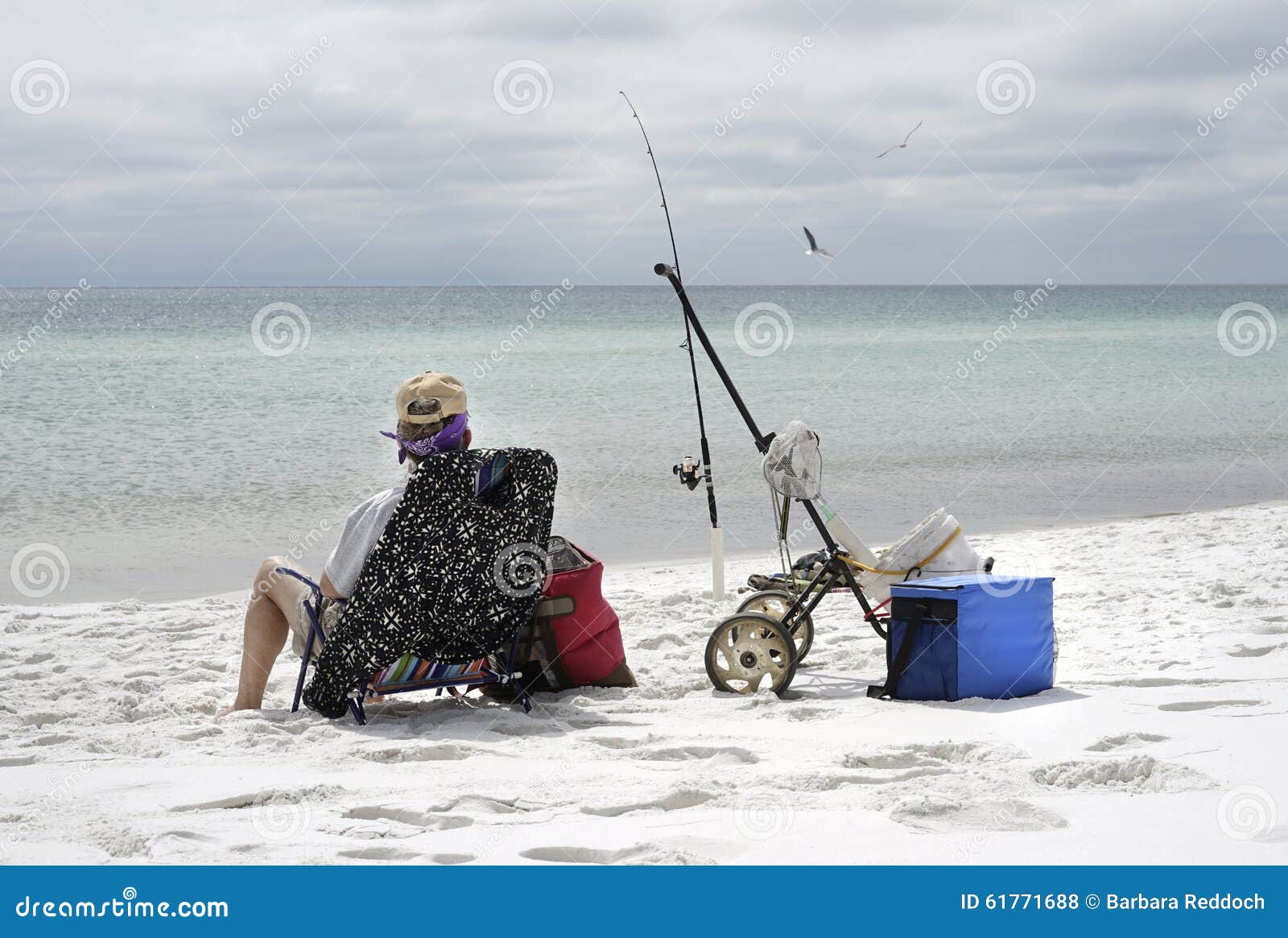 Woman Fishing on Overcast Day at the Beach Stock Photo - Image of fishing,  destination: 61771688