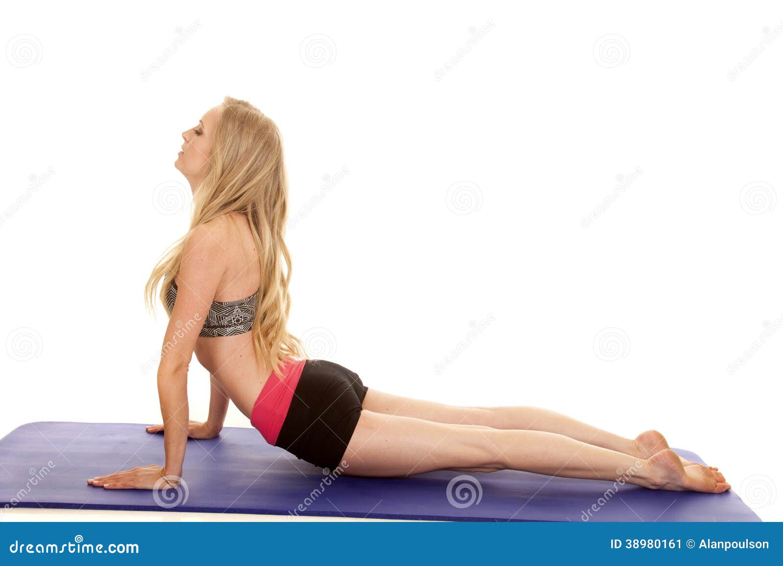 Woman fitness pink black shorts up dog. A woman doing yoga doing upward dog.