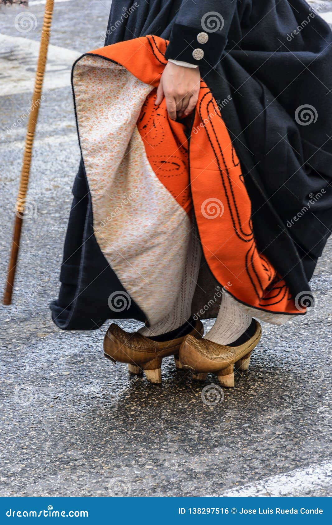 a woman fits motheries, rustic wooden shoes that were used in cantabria spain