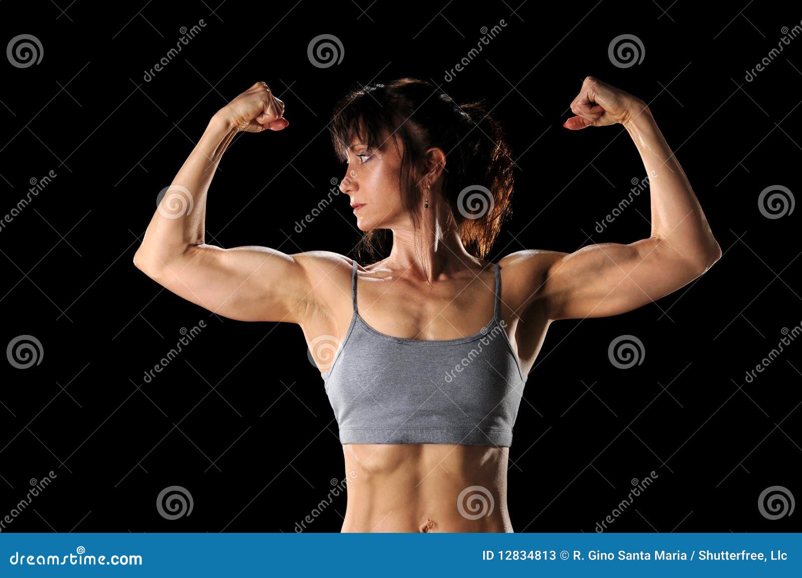 Fotografia do Stock: Sport and women. Rear view of strong fitness athlete,  female bodybuilder, flexing muscles, showing fit body, biceps and athletic  back, smiling satisfied, white background