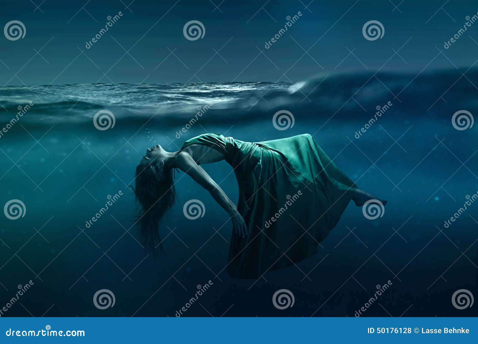 woman floating under water