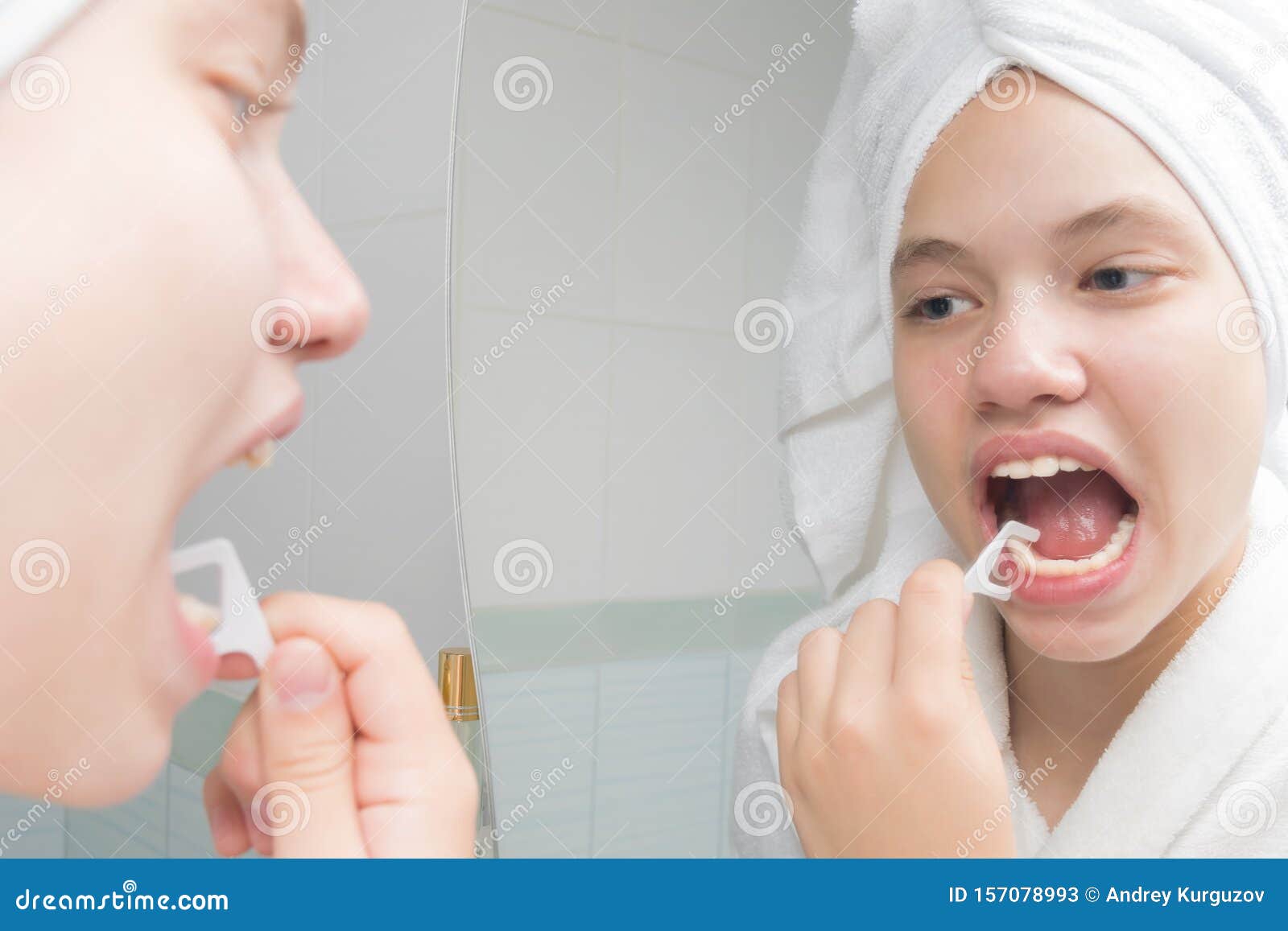 Woman Flossing Teeth Standing in Front of a Mirror Stock Image Image